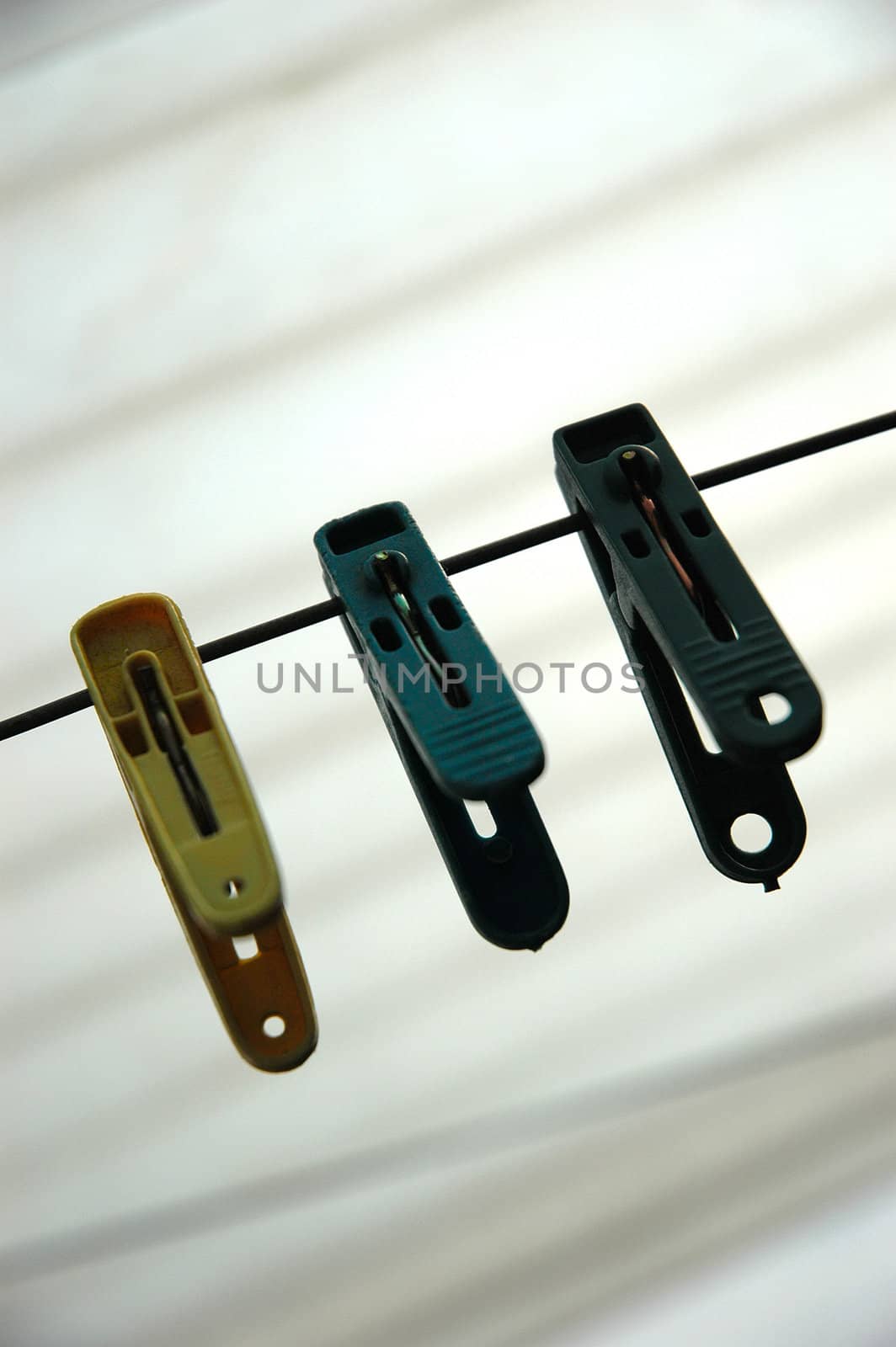 a few cloth pegs hanging on a piece of string