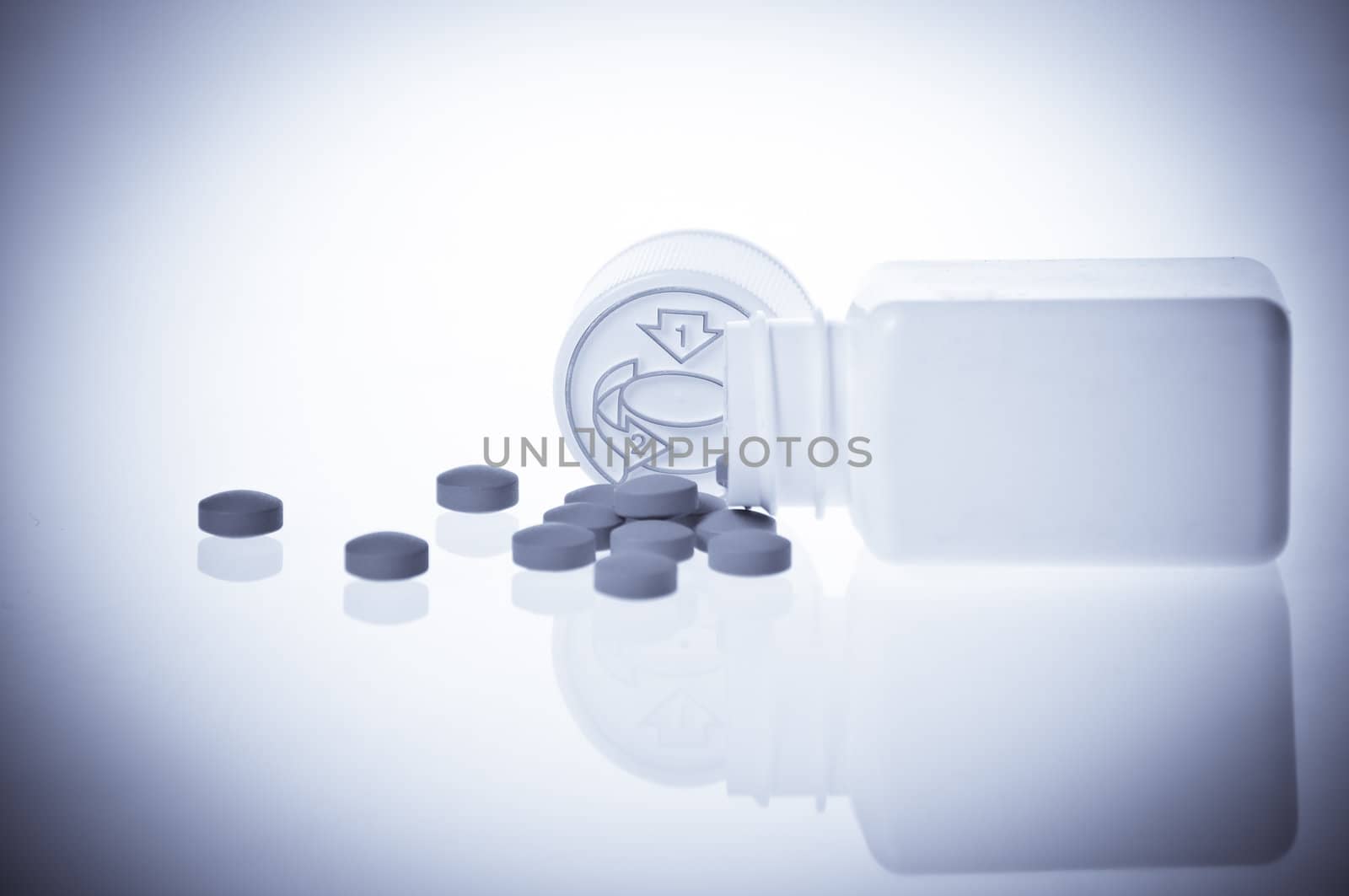 Pills near vintage bottle isolated on white