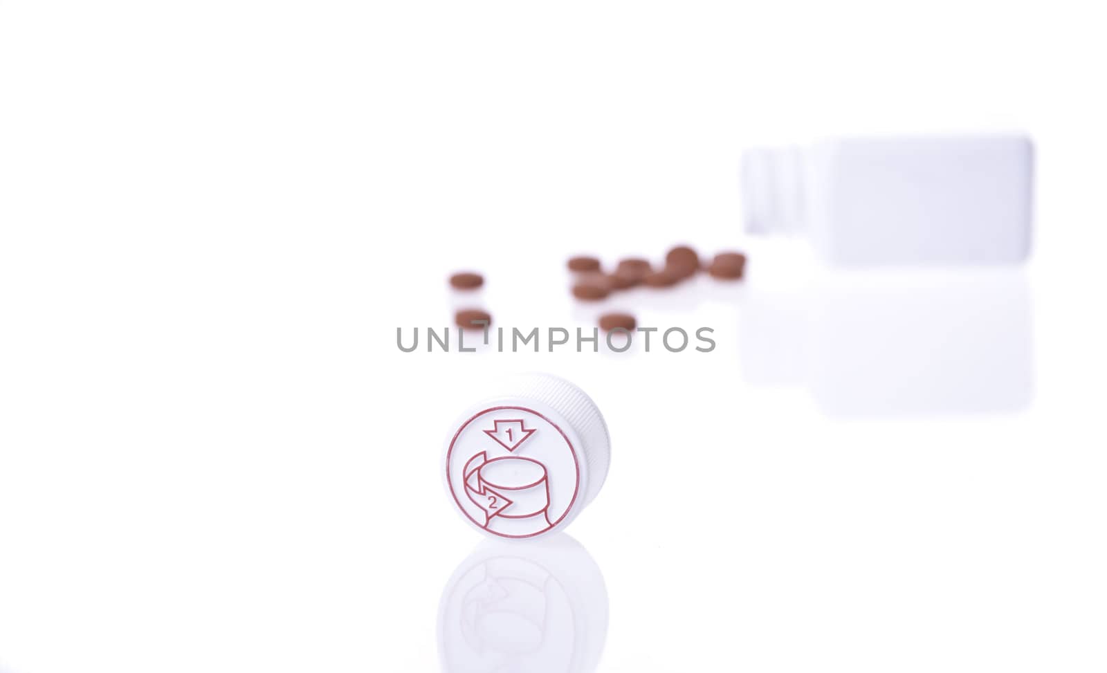 A white pill bottle with red generic pills  on a white background.