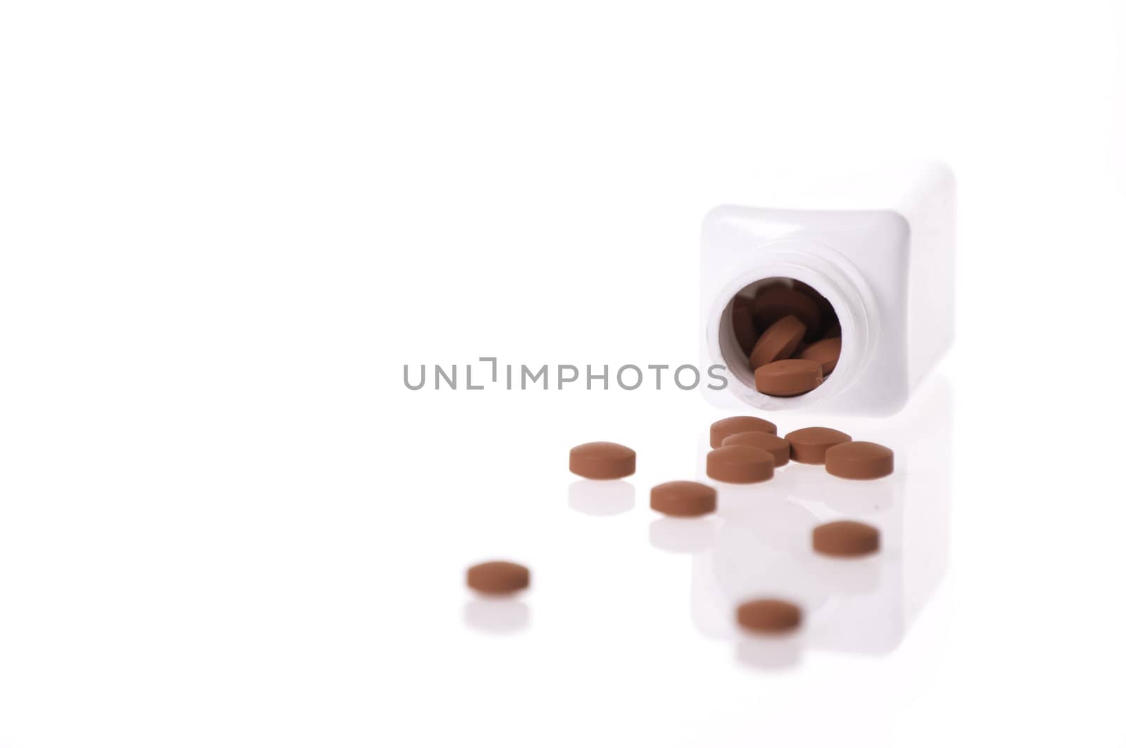 A white pill bottle with red generic pills  on a white background.