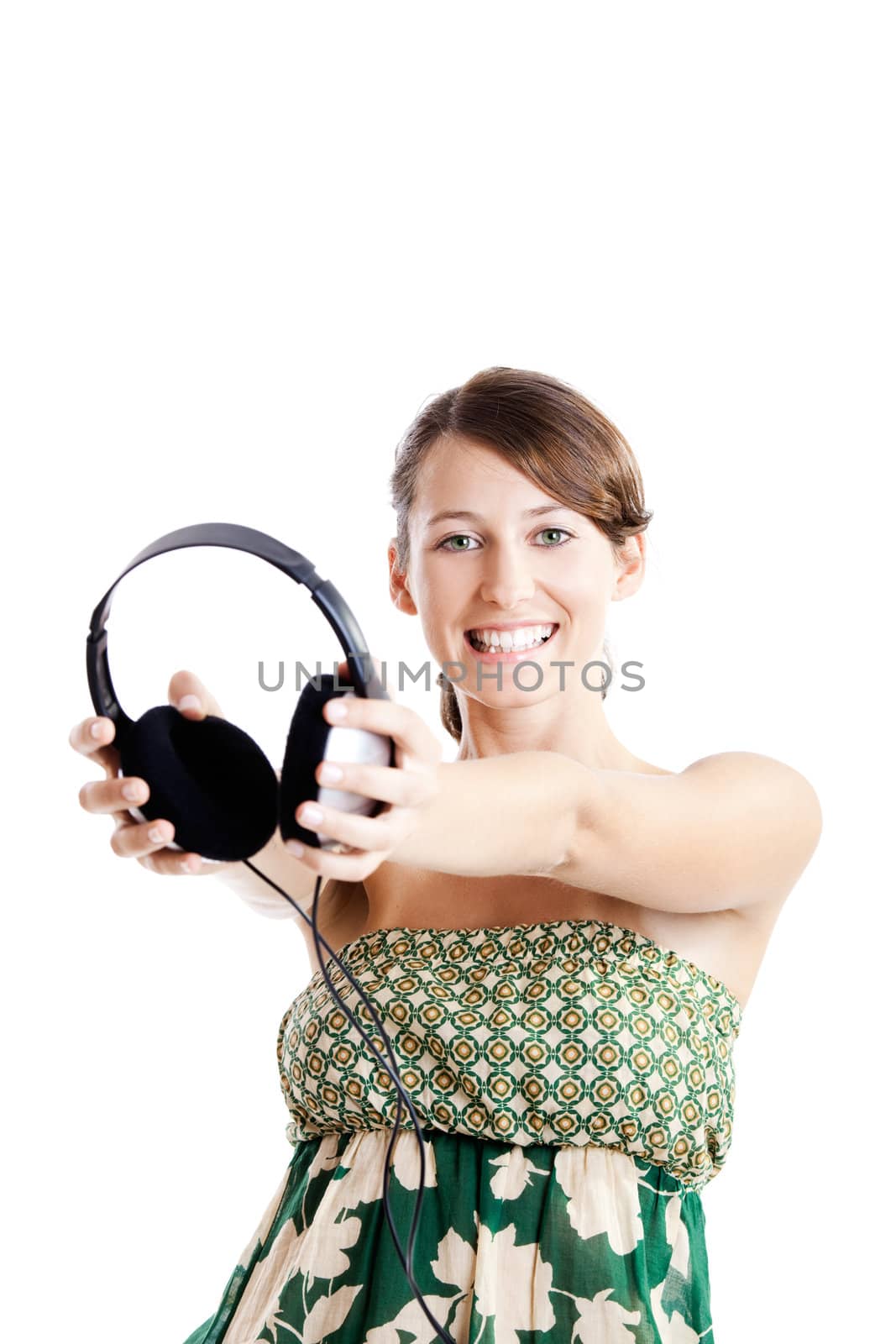 Beautiful young woman holding headphones, isolated on white