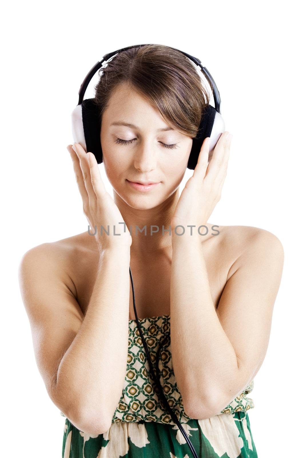 Beautiful young woman listen music with headphones, isolated on white