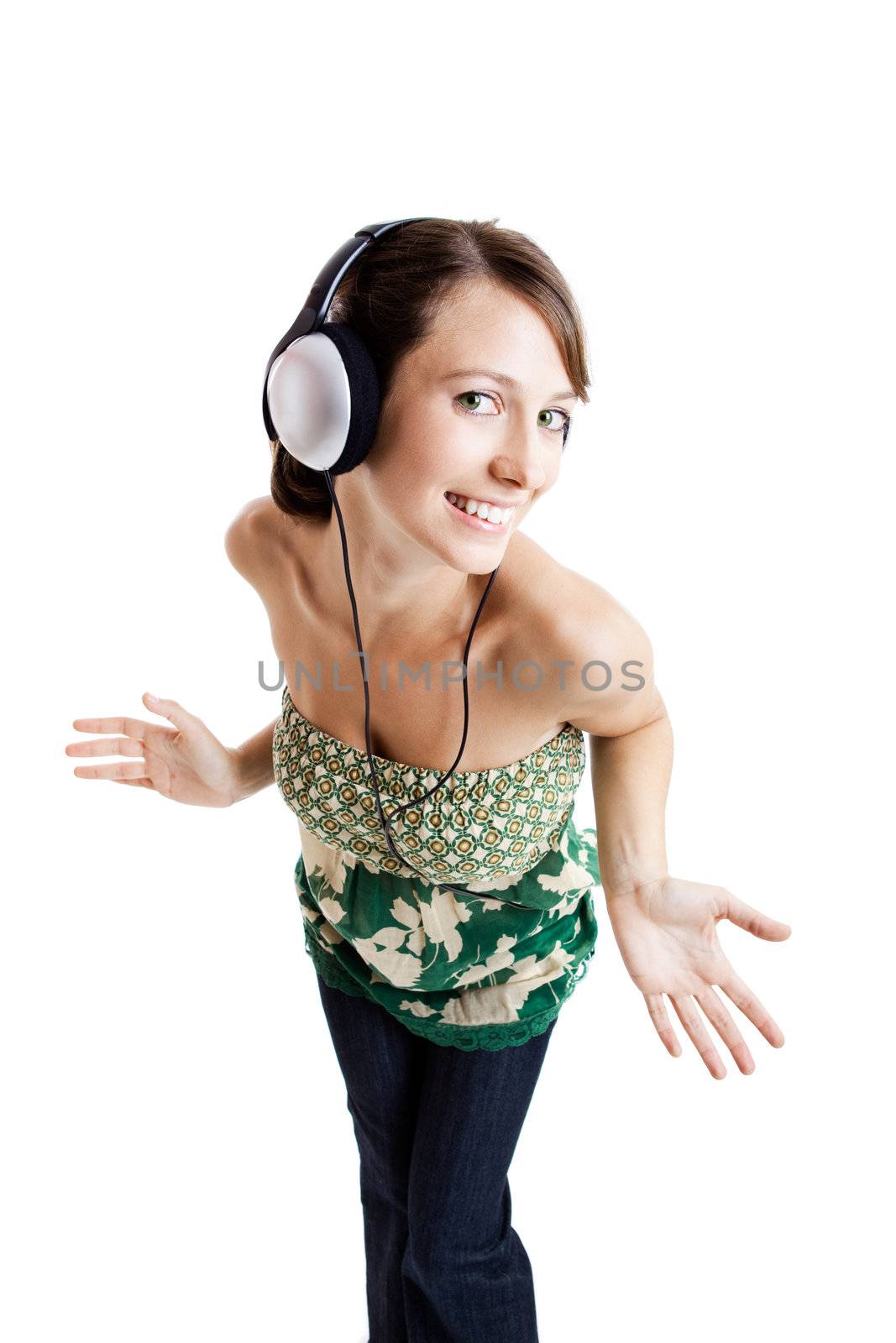 Beautiful young woman listen music and dancing with headphones, isolated on white