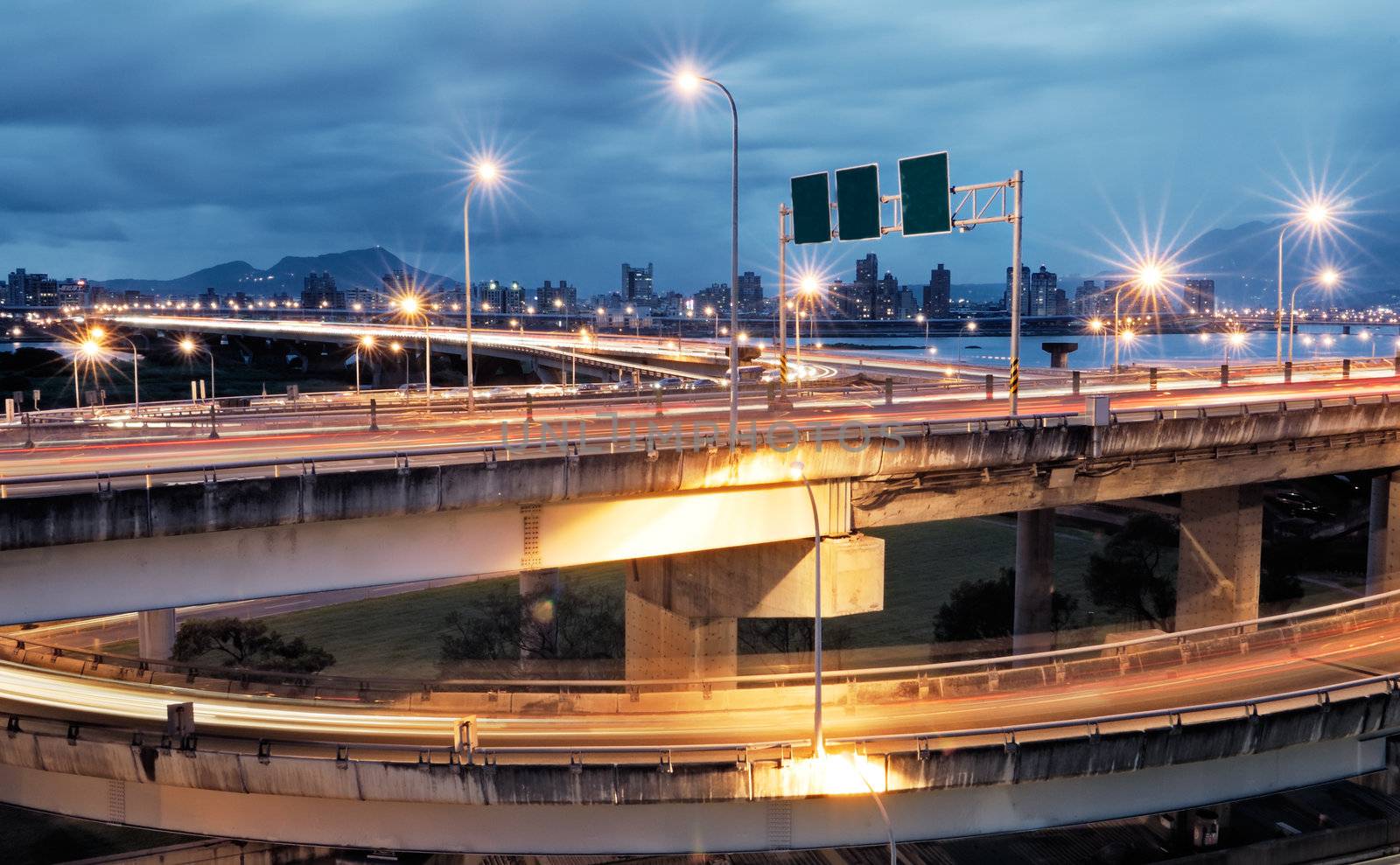 It is a cityscape of interchange with cars light.