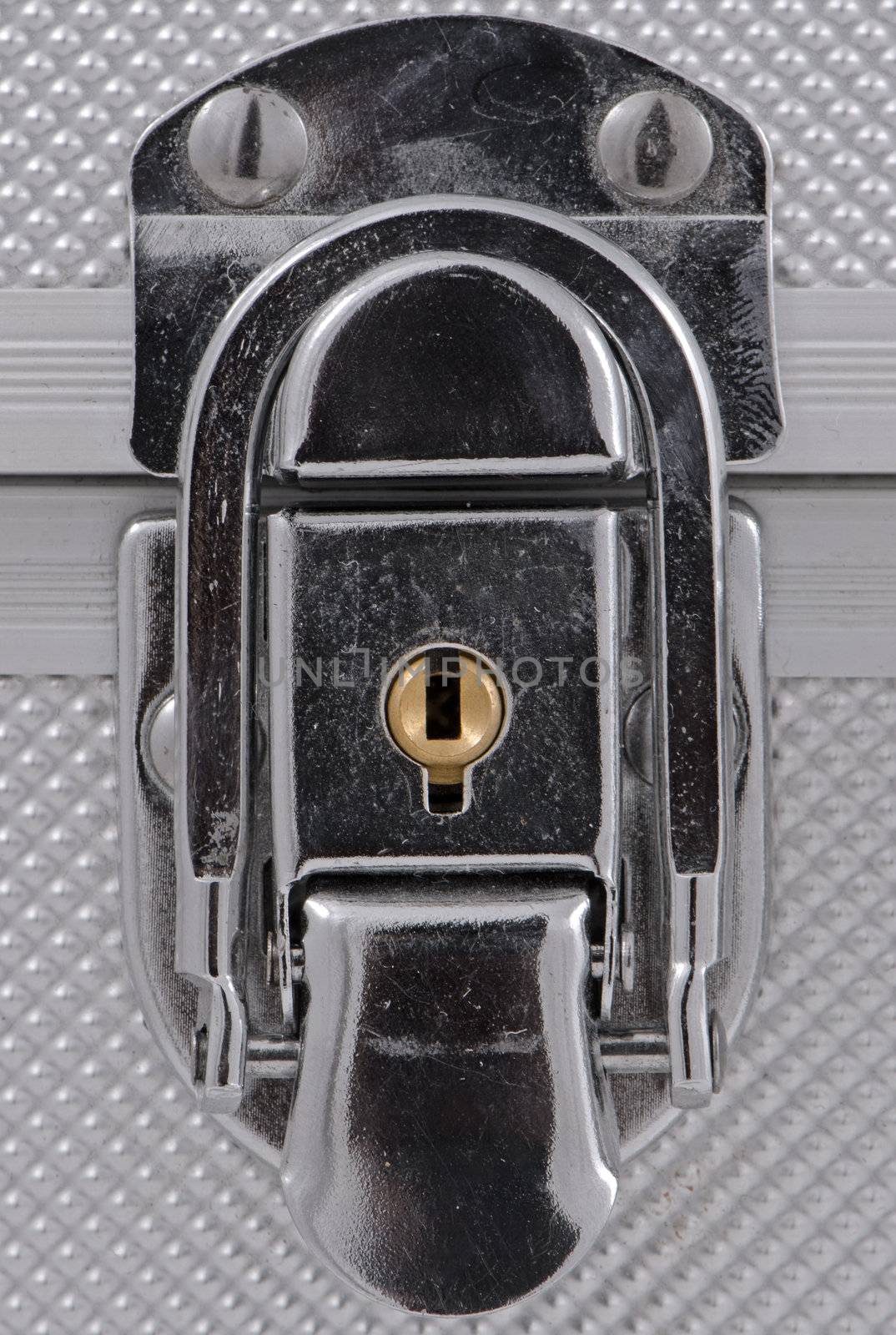 Shiny metal case lock closeup.