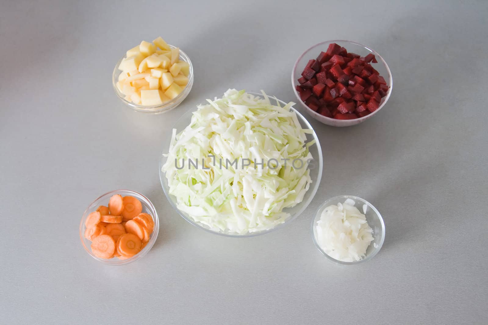 Five bowls with chopped vegetables, ingredients for vegetable soup