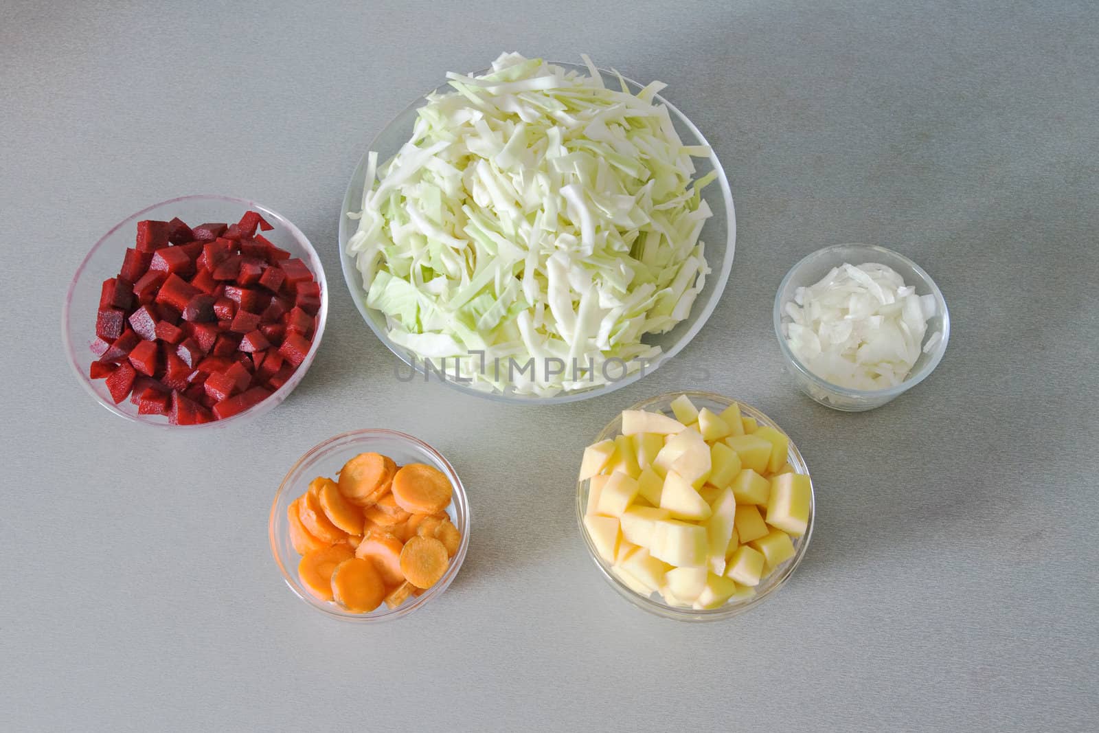Five bowls with chopped vegetables, ingredients for vegetable soup