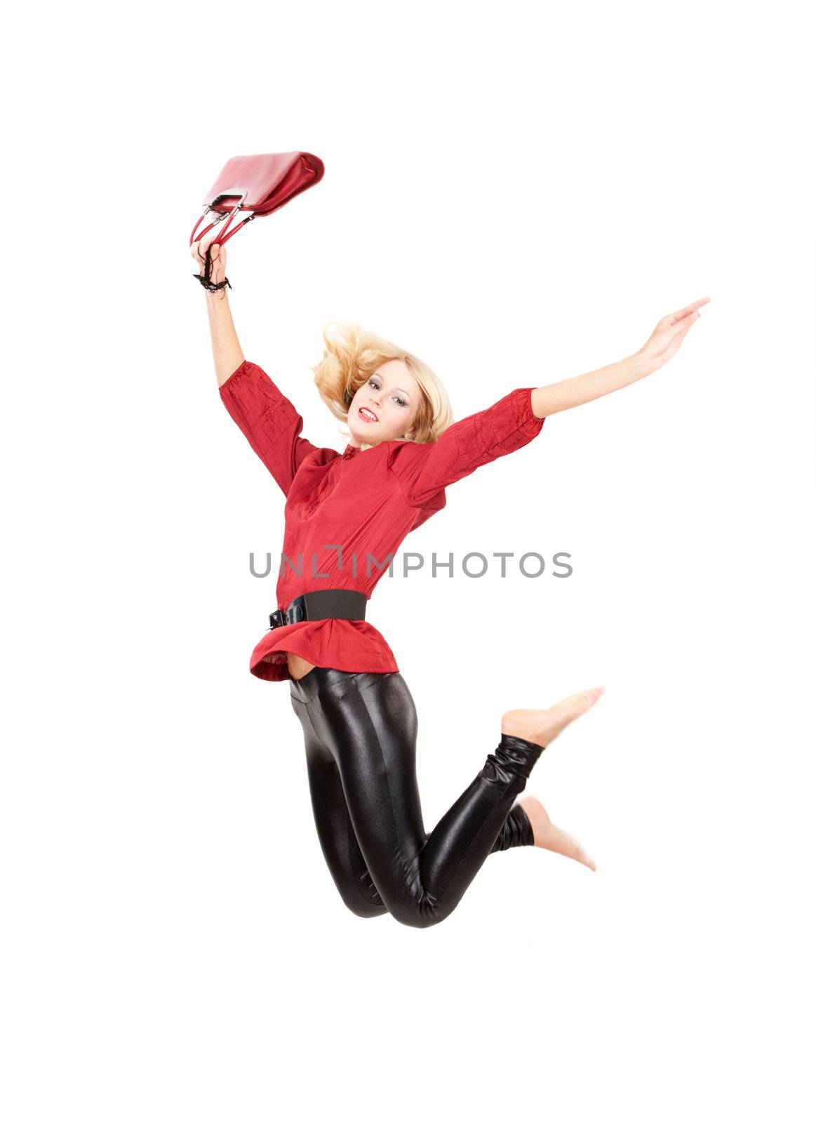 Jumping woman in red top and black leggins over white isolated background