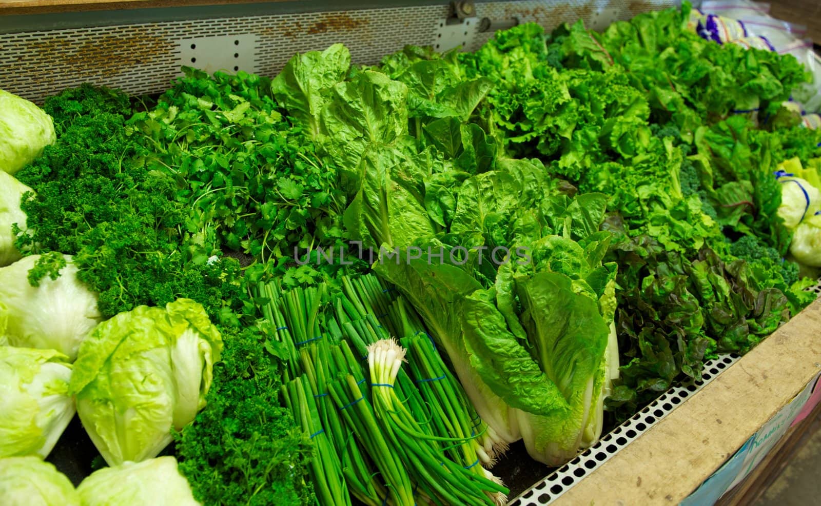 Bright Green Produce in Grocery Store Bin by pixelsnap