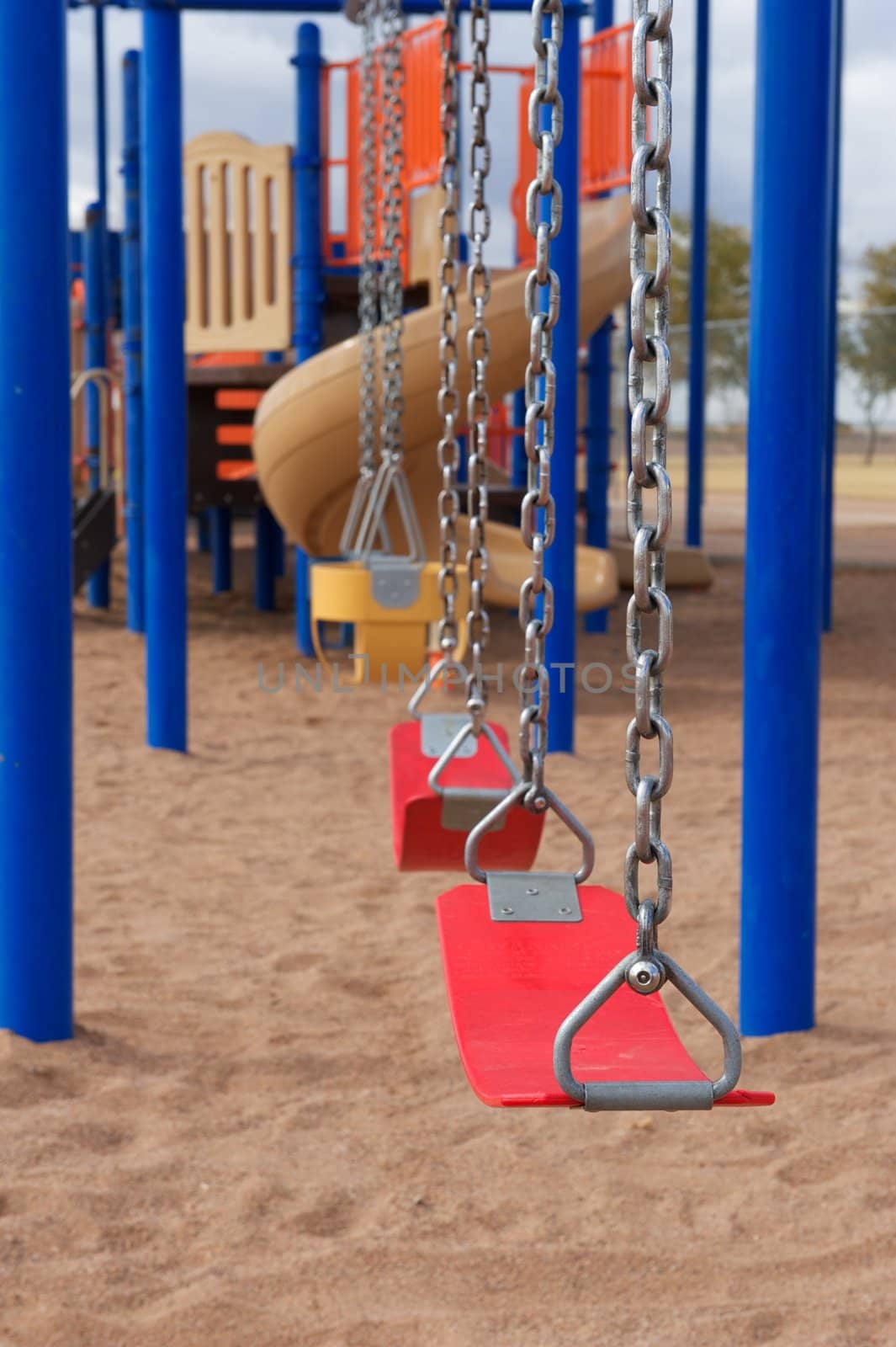 A vertical shot of school or park playground equipment with flexible swings