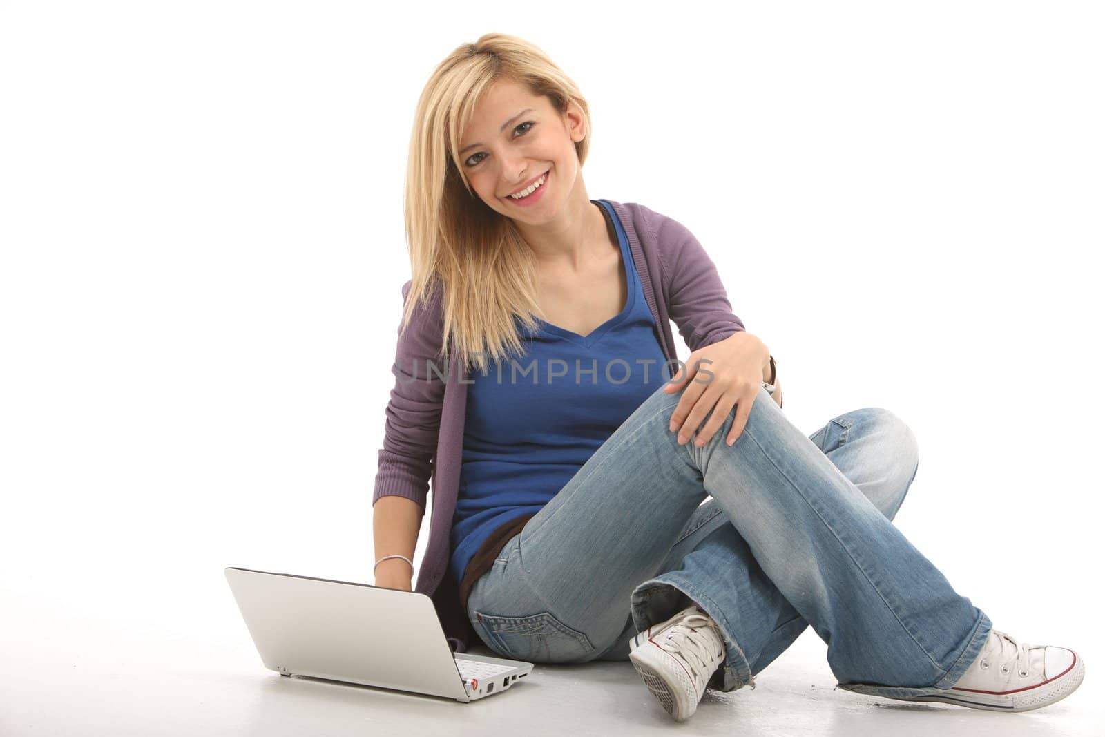 Smiling girl connected with her laptop on a white background