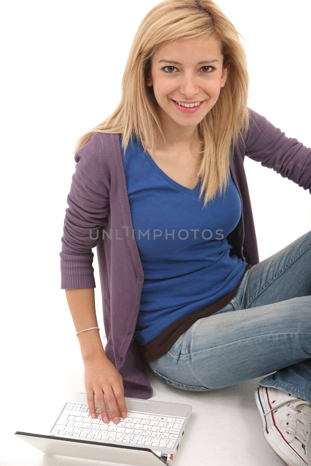 Smiling girl connected with her laptop on a white background