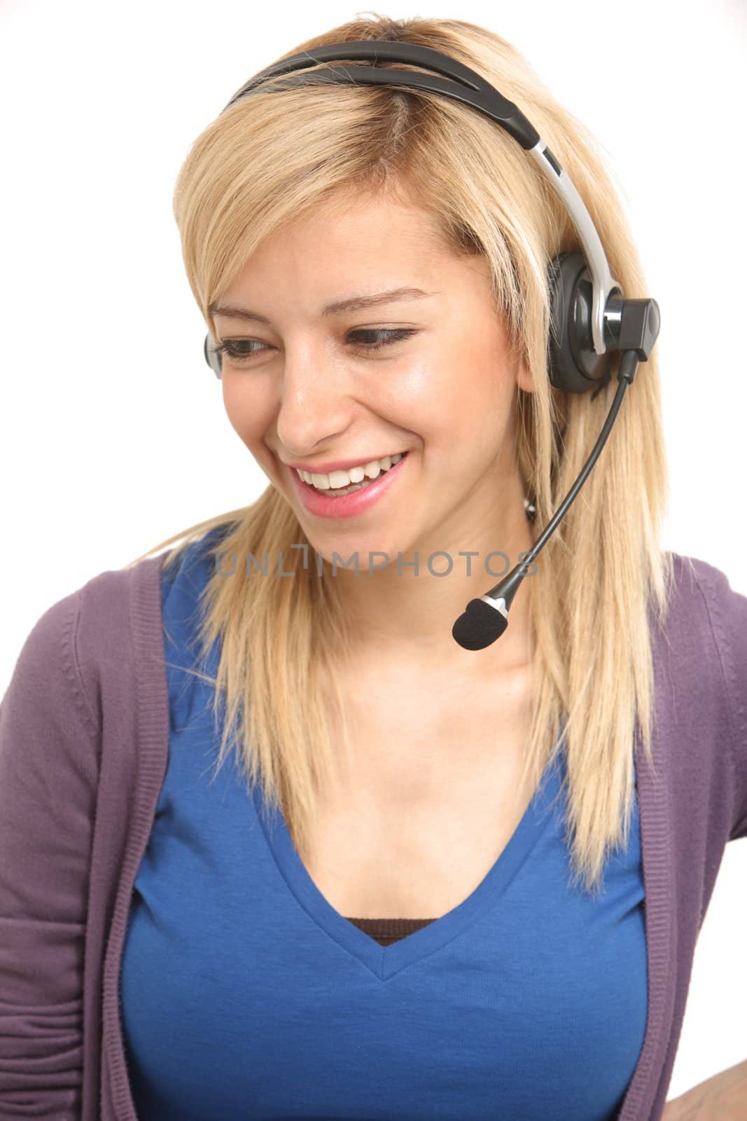 A smiling blonde girl answering with a headset