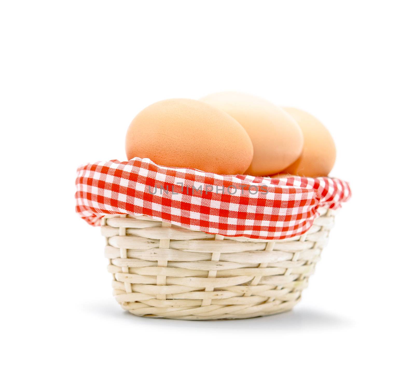 Brown eggs in a basket isolated on white background