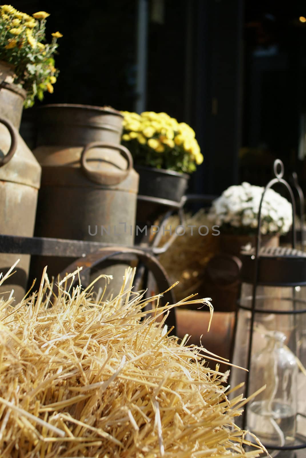 Straw with old milk-cans in the back.