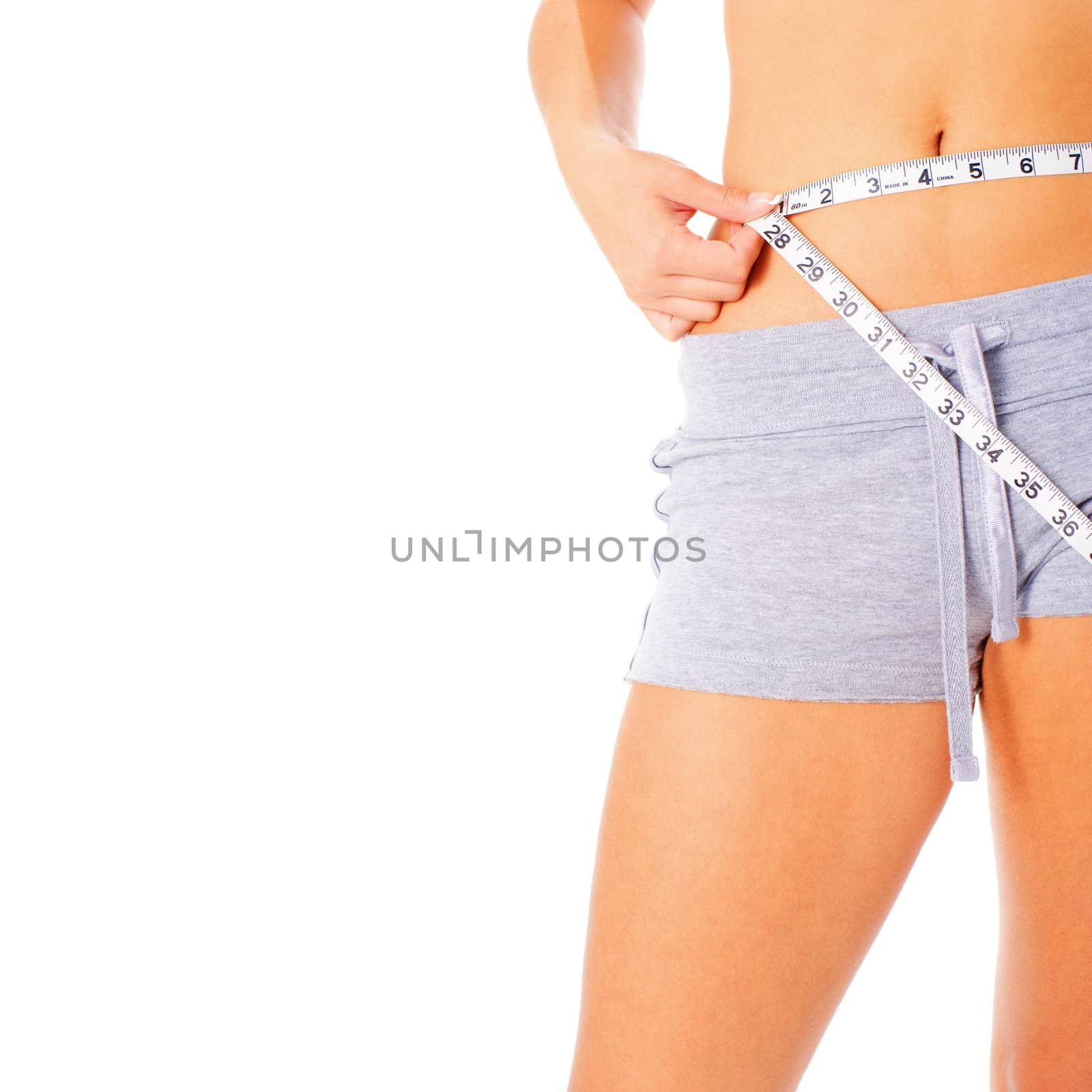 Young woman measuring herself with a measuring tape, from a complete series of photos.