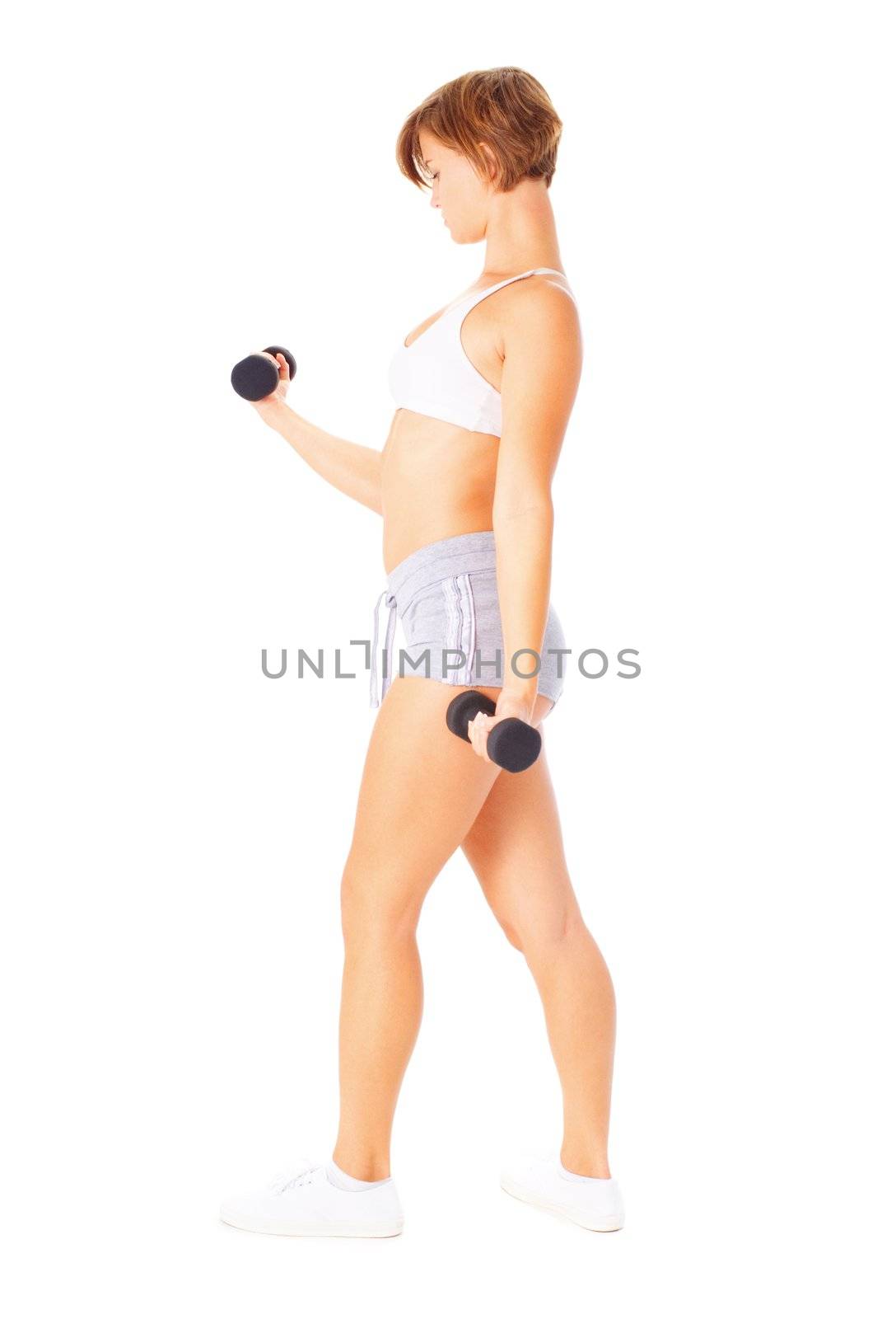 Young woman isolated on white lifting weights, from a complete series of photos.