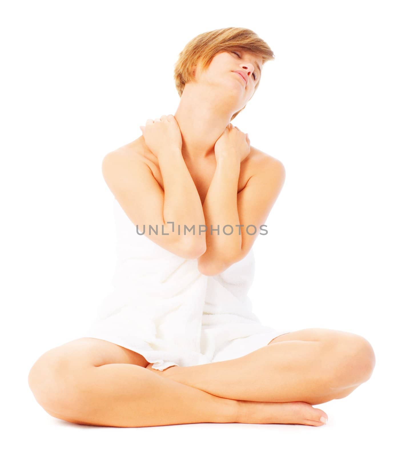 Woman in towel massaging her shoulders, from a complete series of photos.