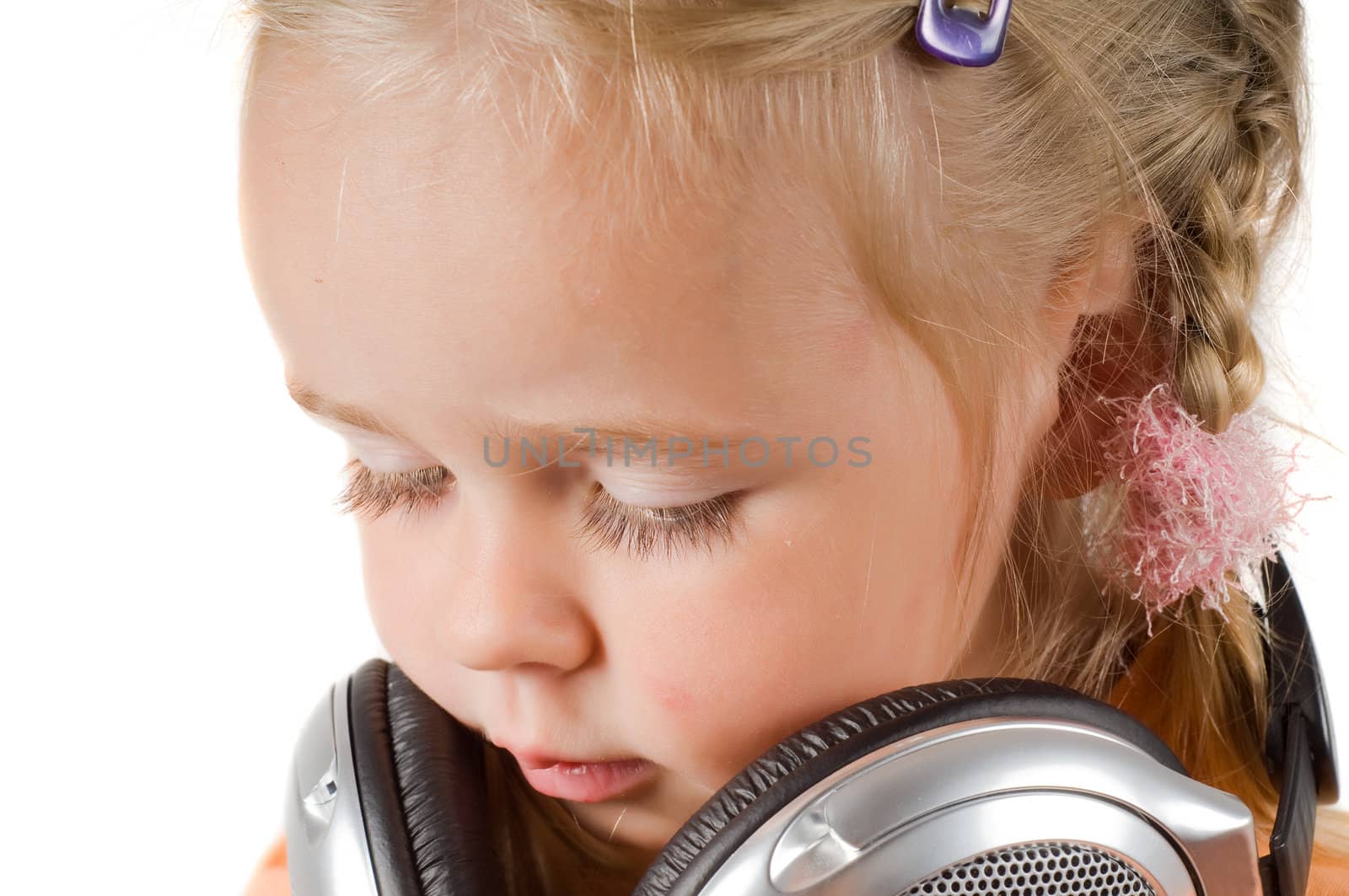 Shot of little girl with headphones in studio