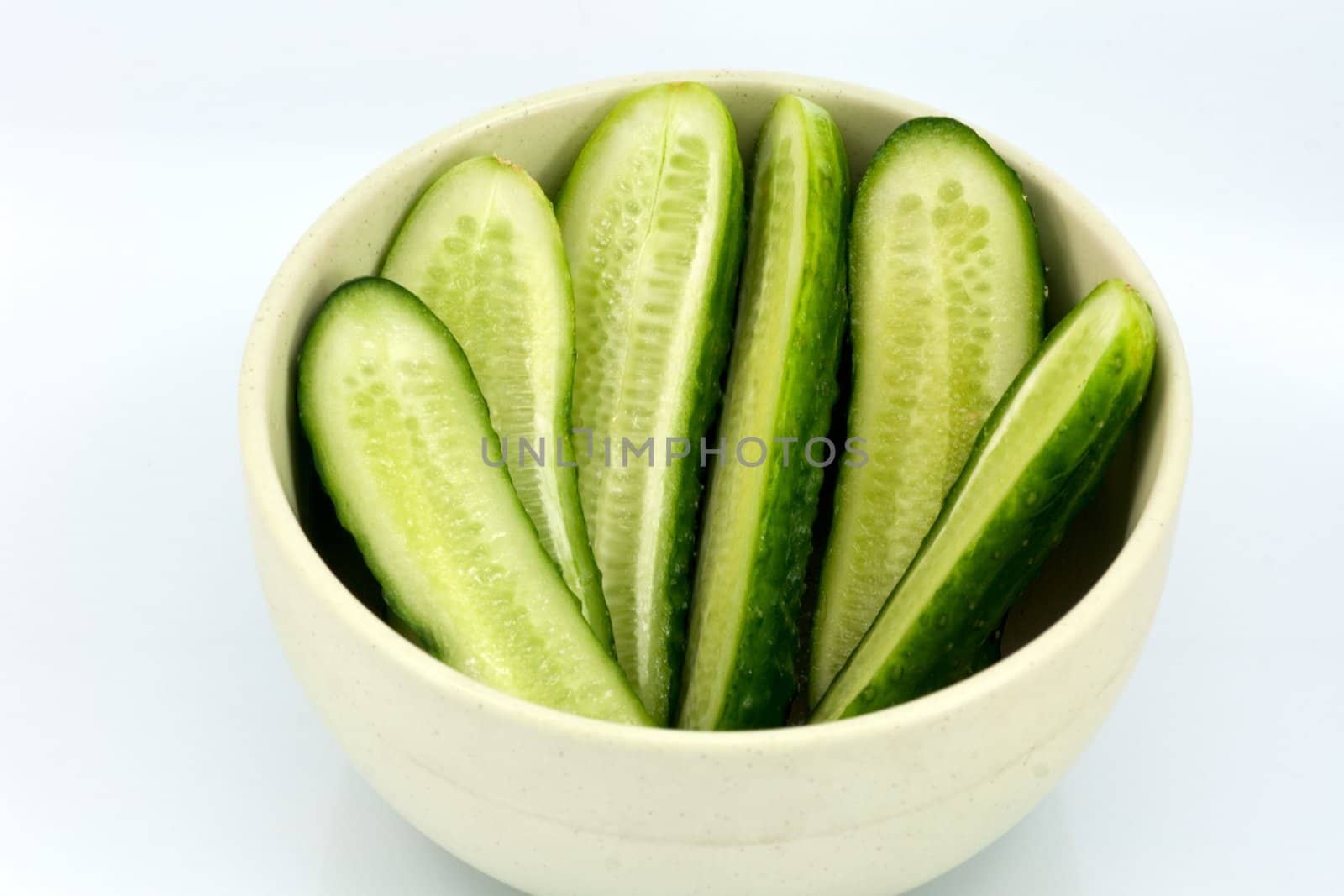 Sliced cucumber in the dish by helgy