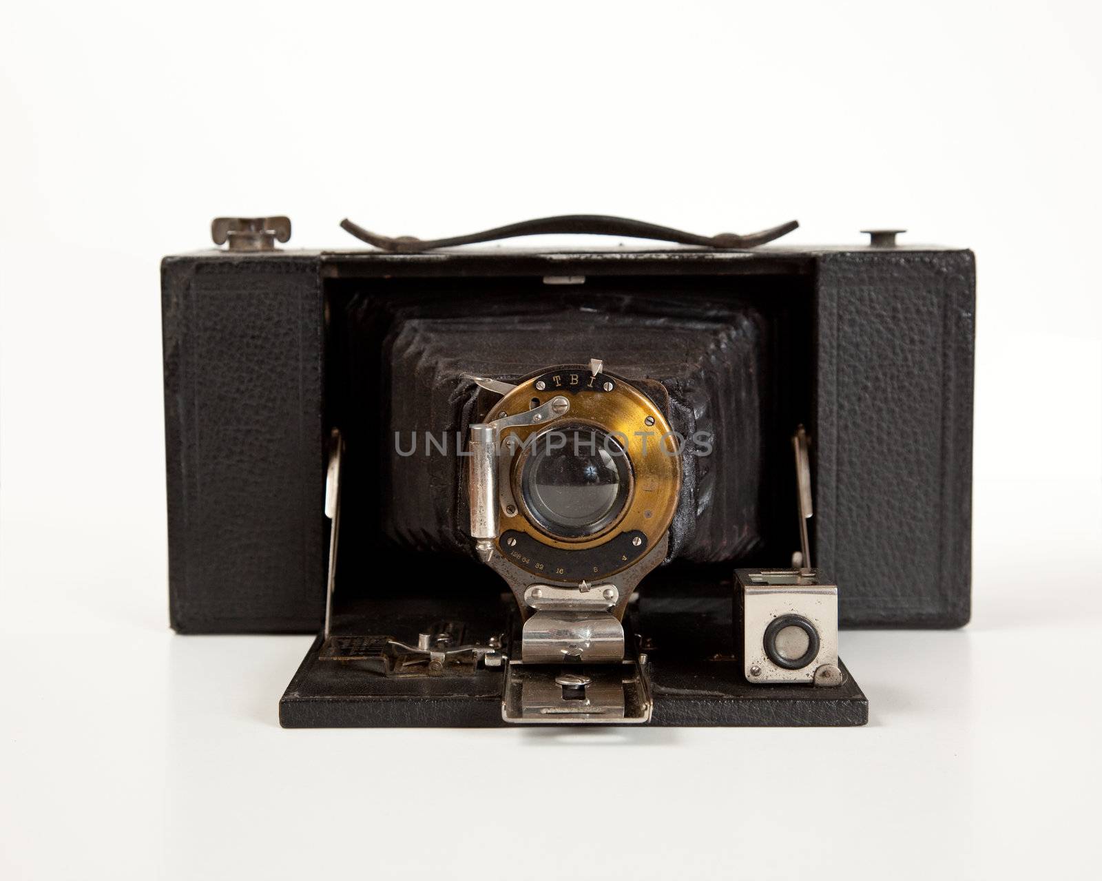 Antique bellows camera in front view isolated on white