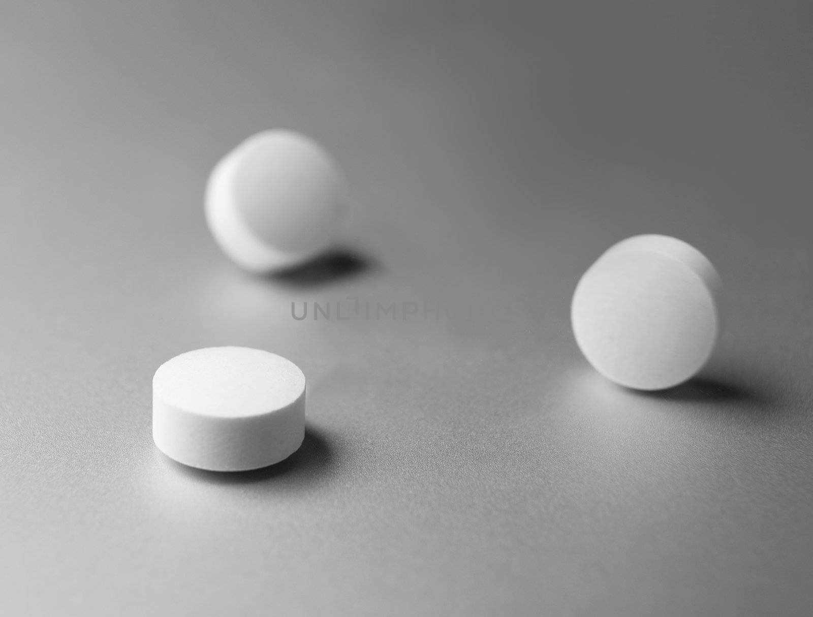 Three pills at silver background by gemenacom