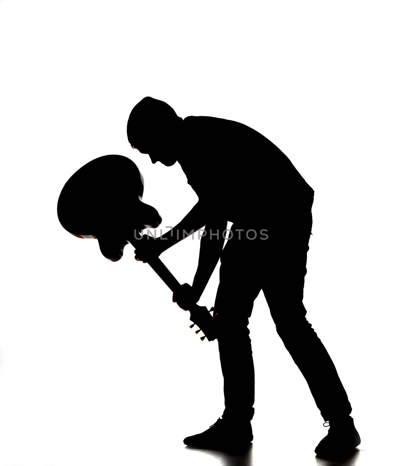 silhouette of a man smashing his guitar by gemenacom