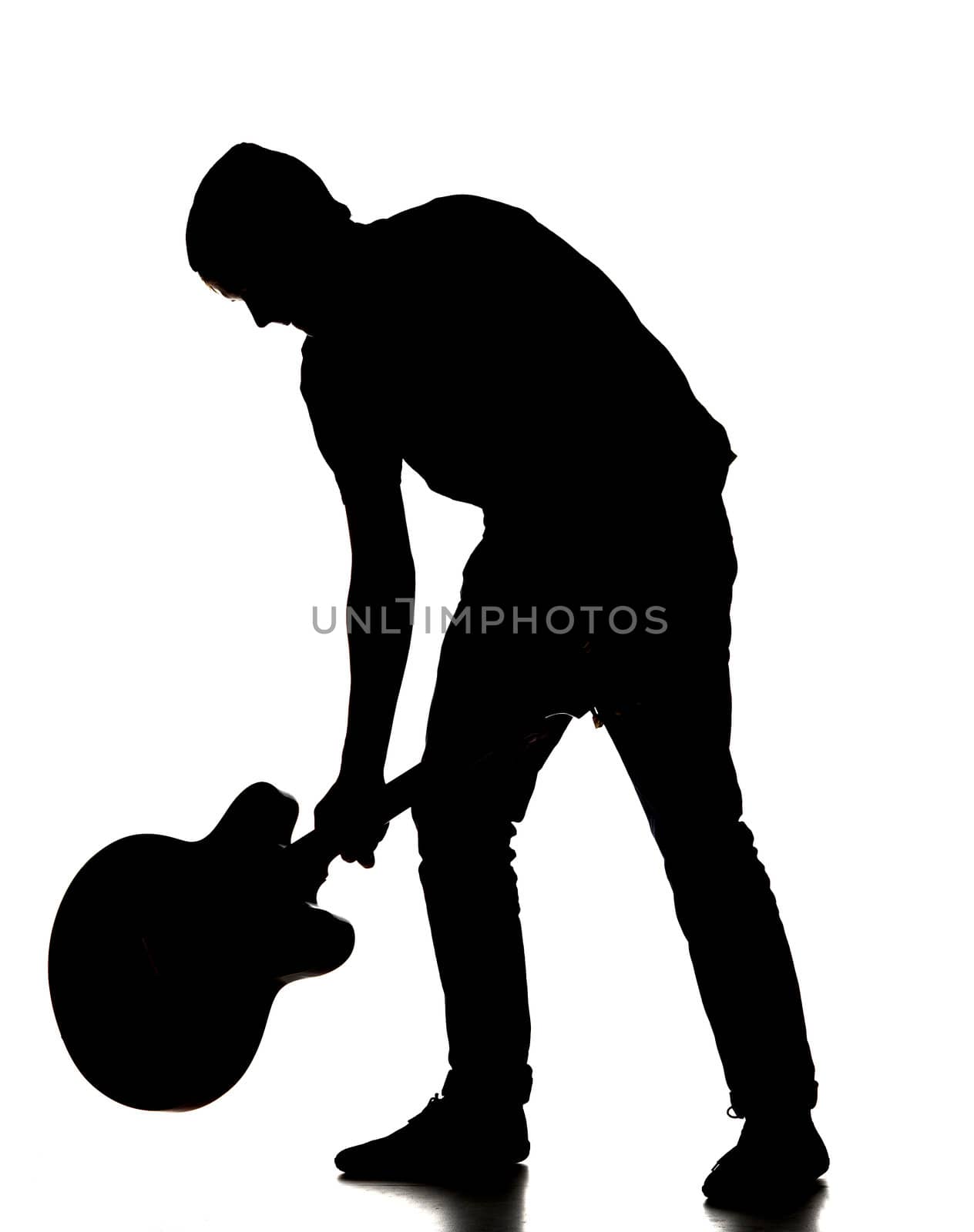 silhouette of a man smashing his guitar by gemenacom