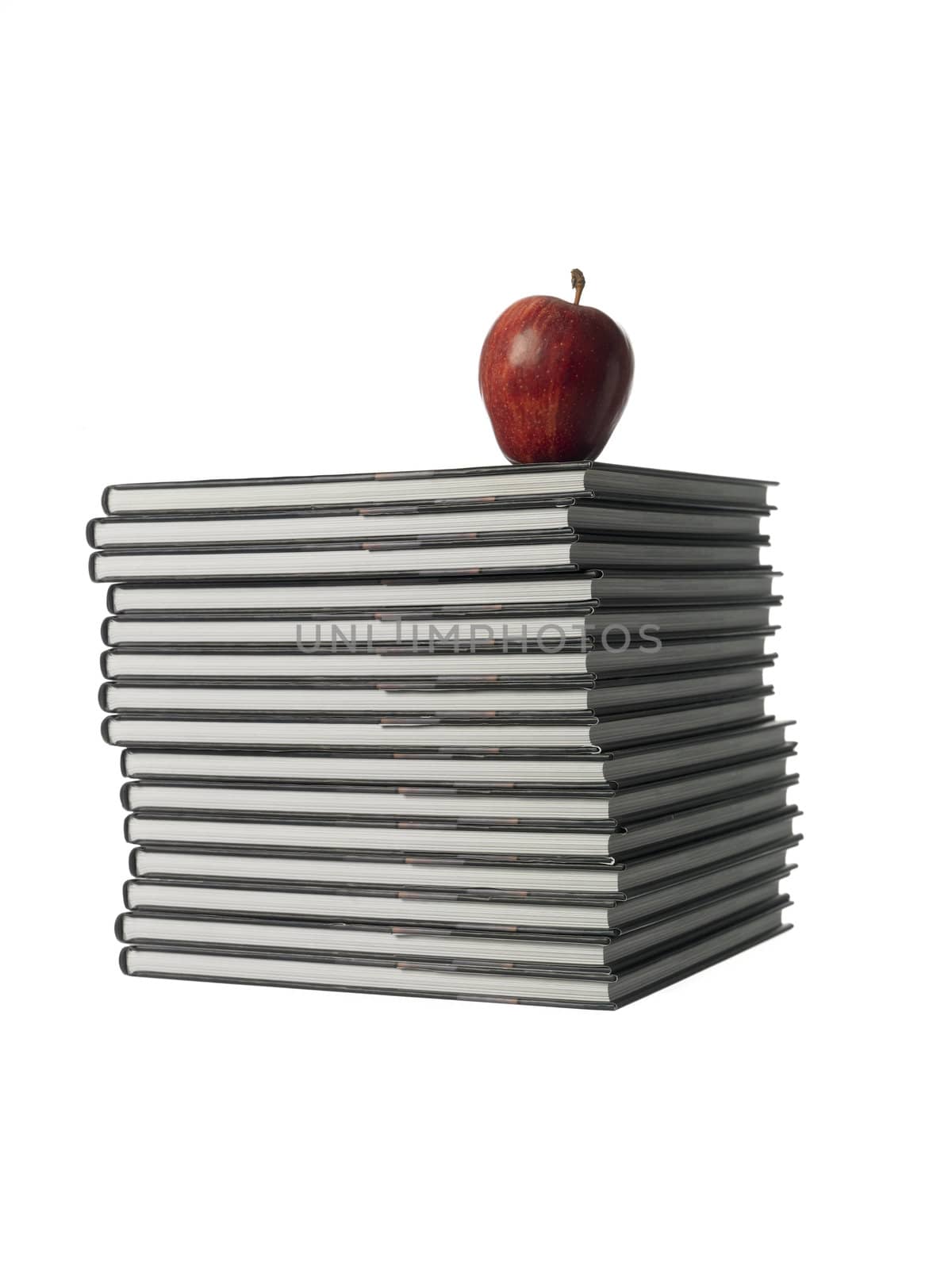pile of books with a apple by gemenacom