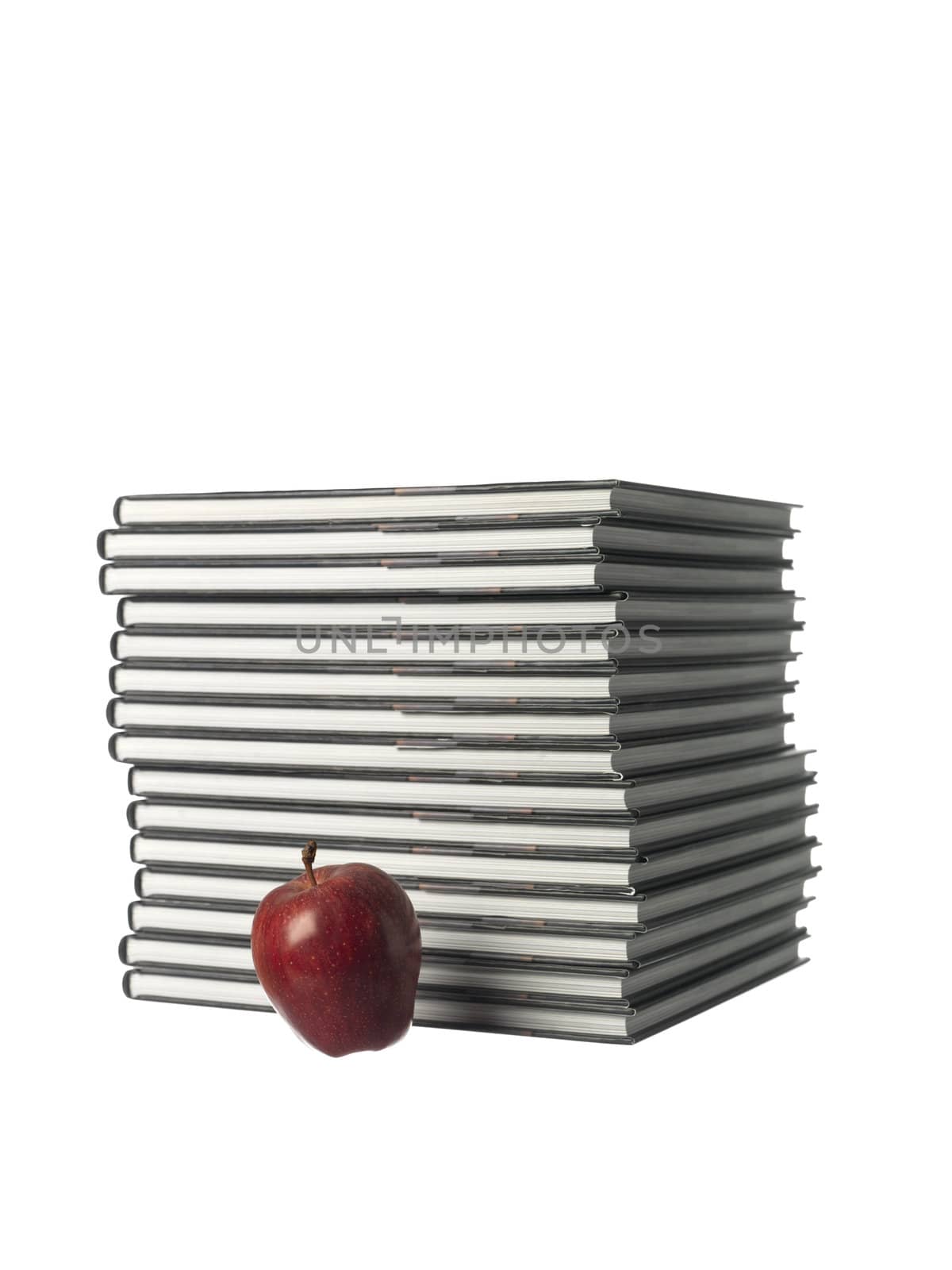 pile of books with a apple