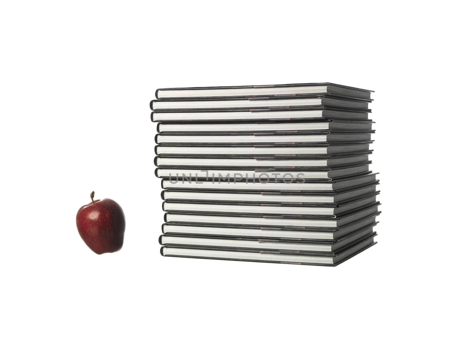 pile of books with a apple by gemenacom
