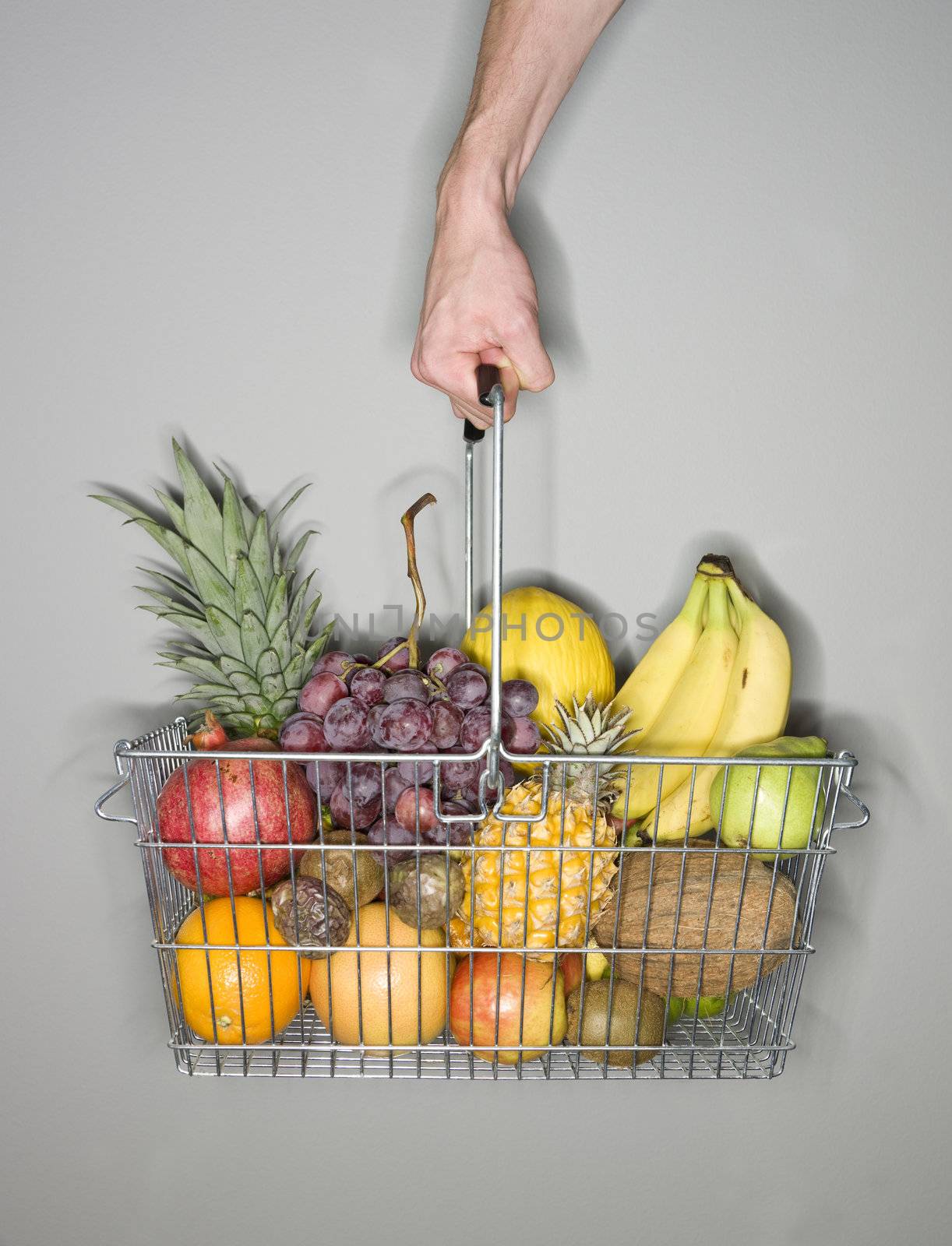 Holding a shopping-basket of fruit by gemenacom