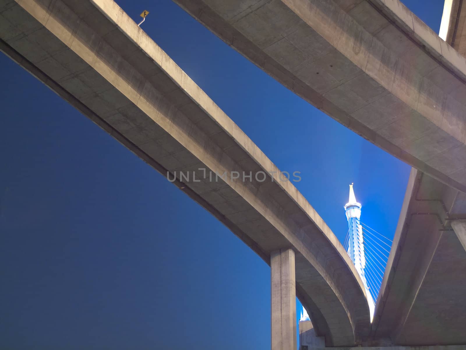 Intersection expressway with grade separation illuminate with spotlight on deep blue sky, Bhumibol Bridge, Samut Prakarn,Thailand