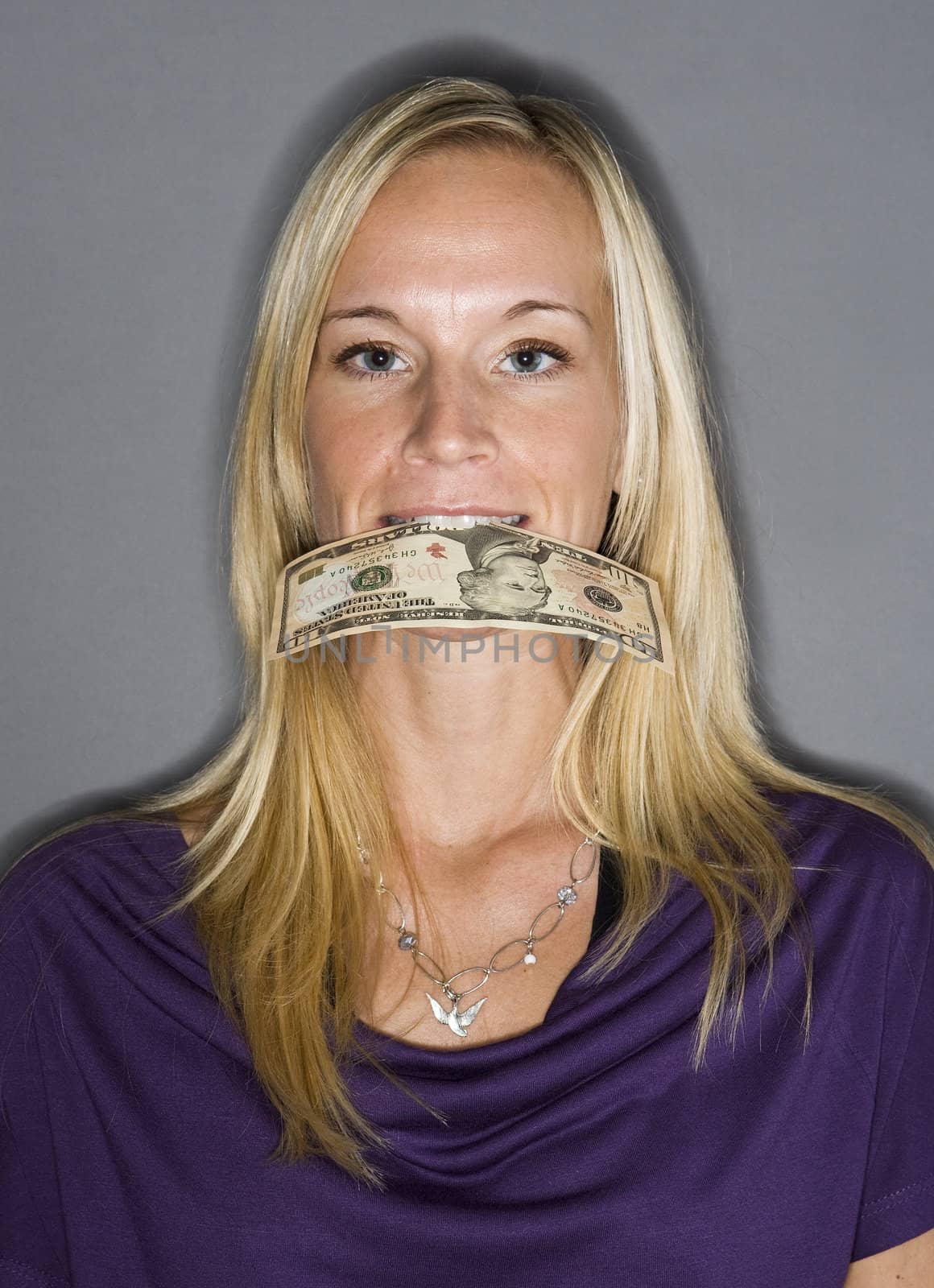 Woman with a dollar-bill in her mouth