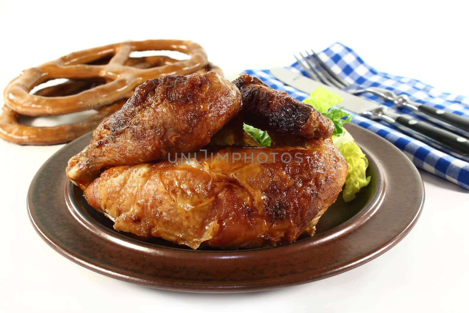 a roast chicken with salad on a plate