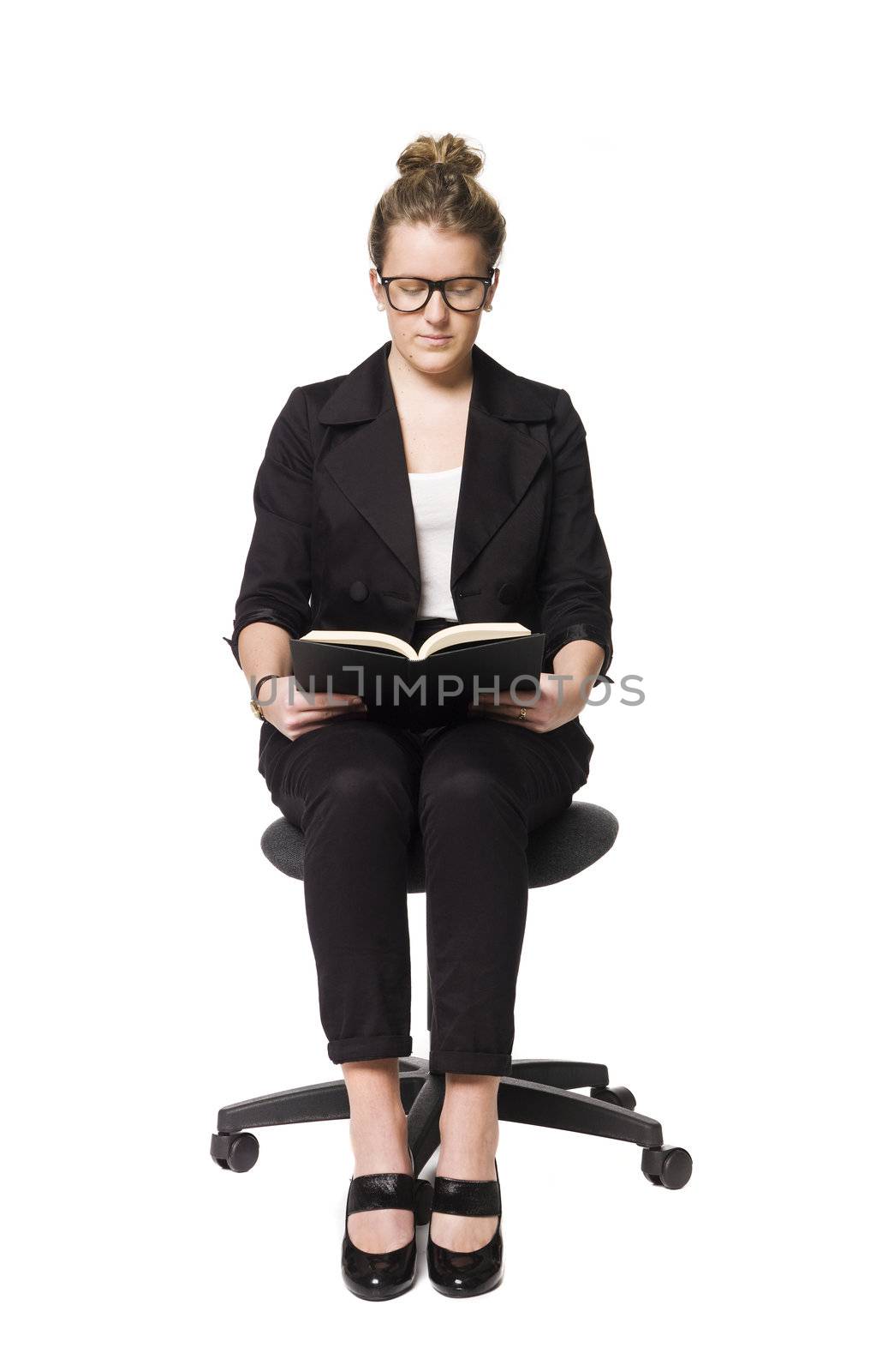 Buisnesswoman sitting on a chair with a book