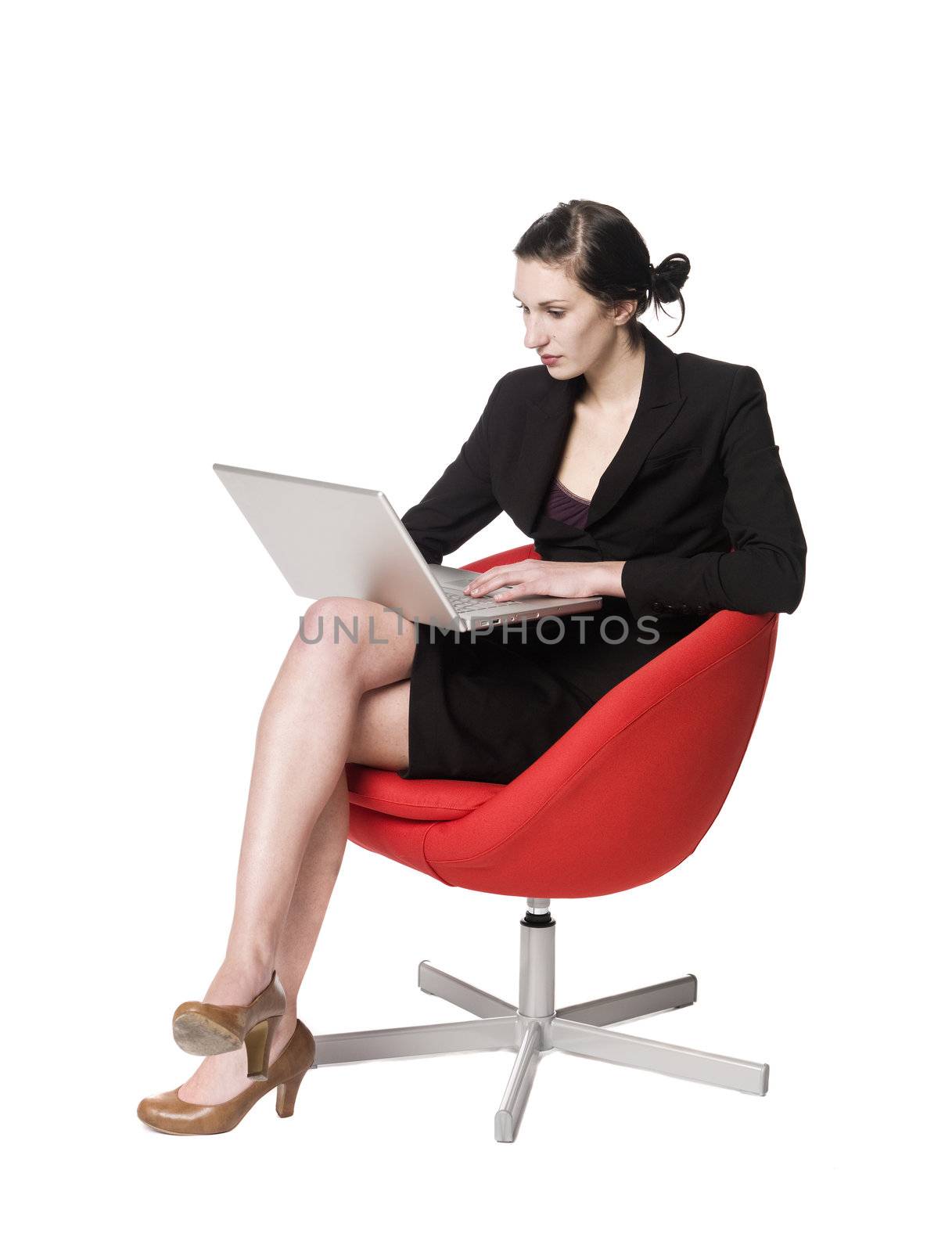 Woman with a power-book sitting in a chair
