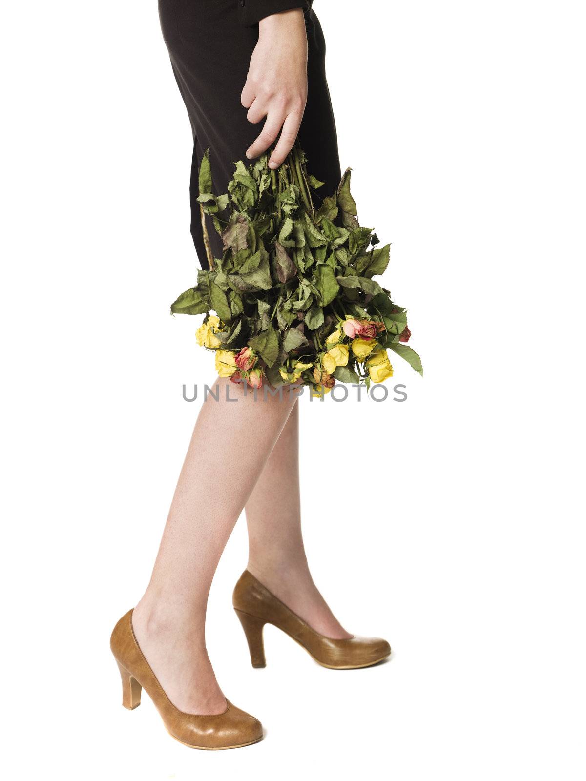 Woman holding a bunch of dead flowers