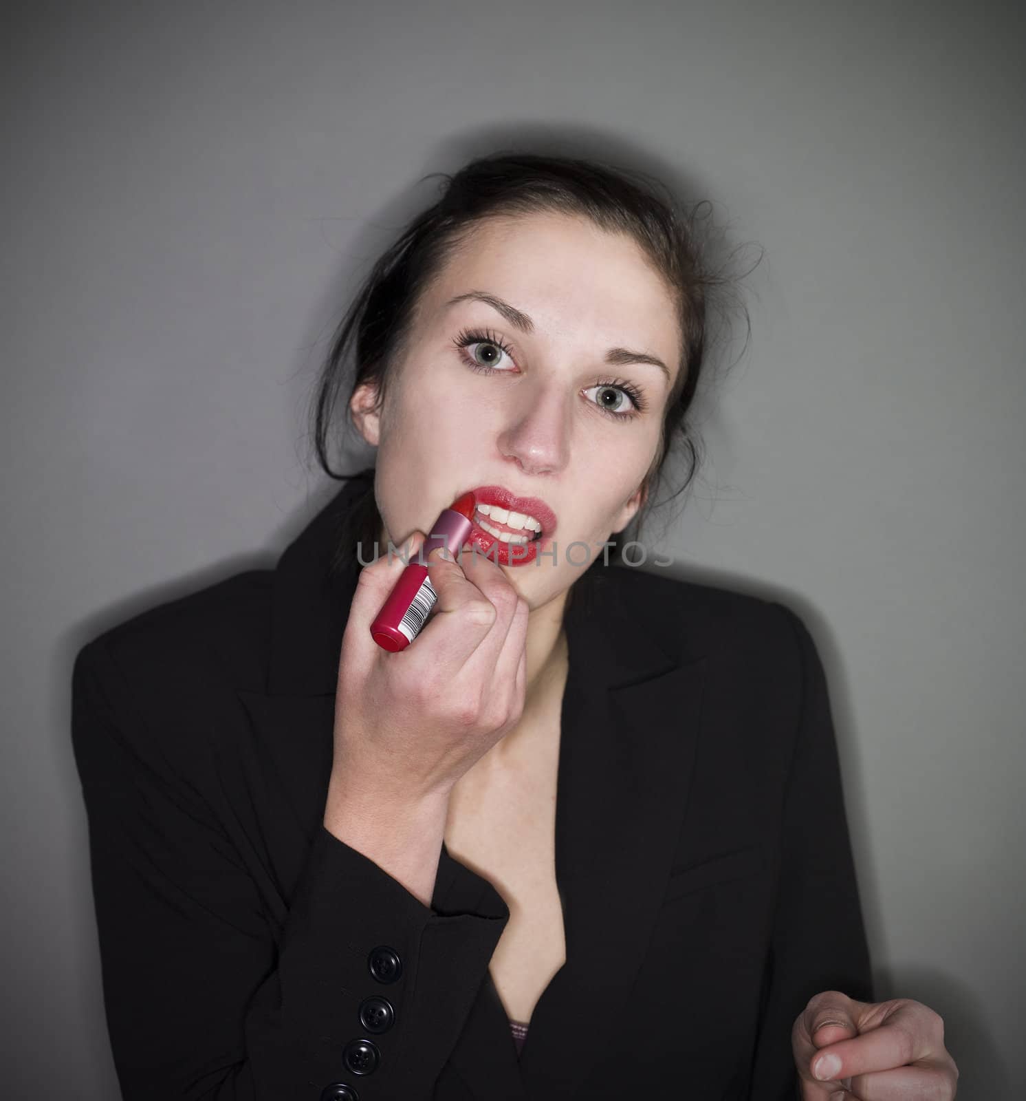 Woman put on lipstick by gemenacom