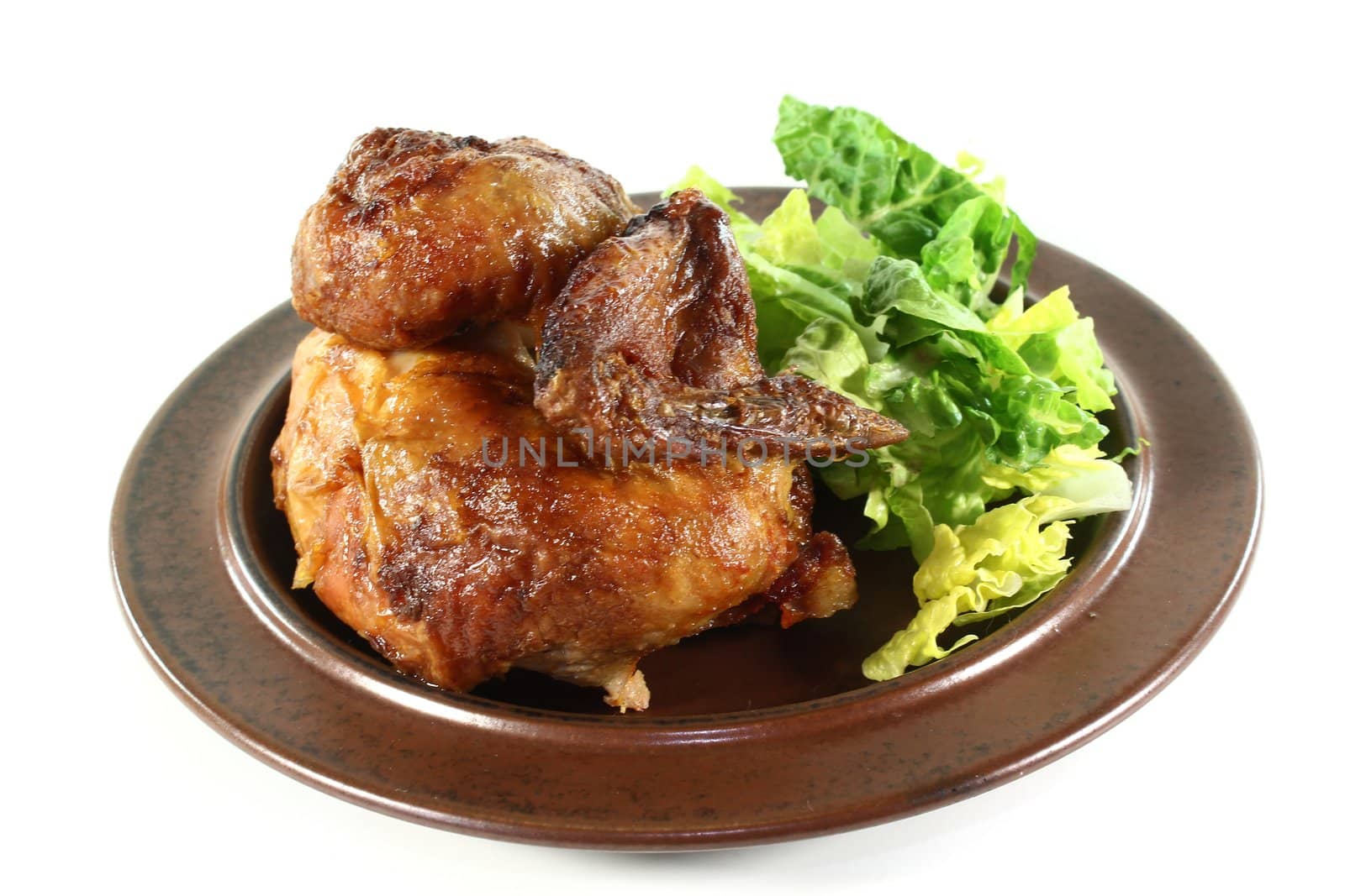 a roast chicken with salad on a plate