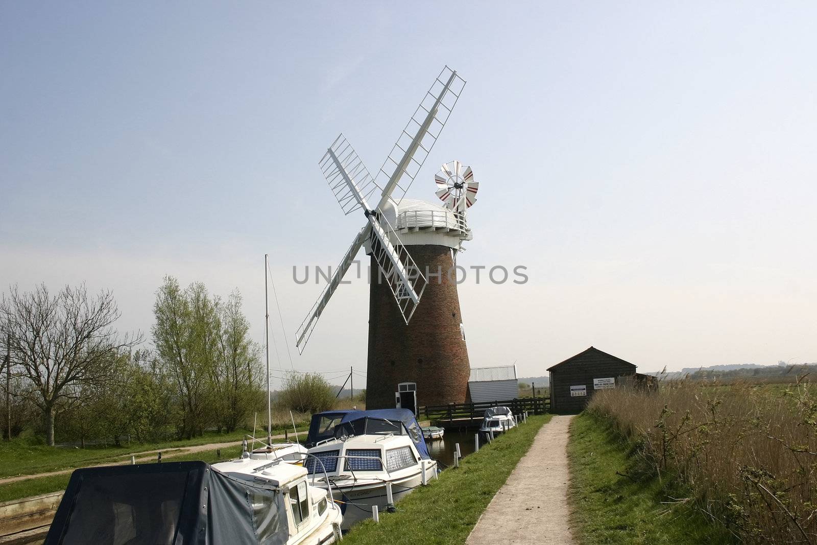 windmill and boats set against the sky line