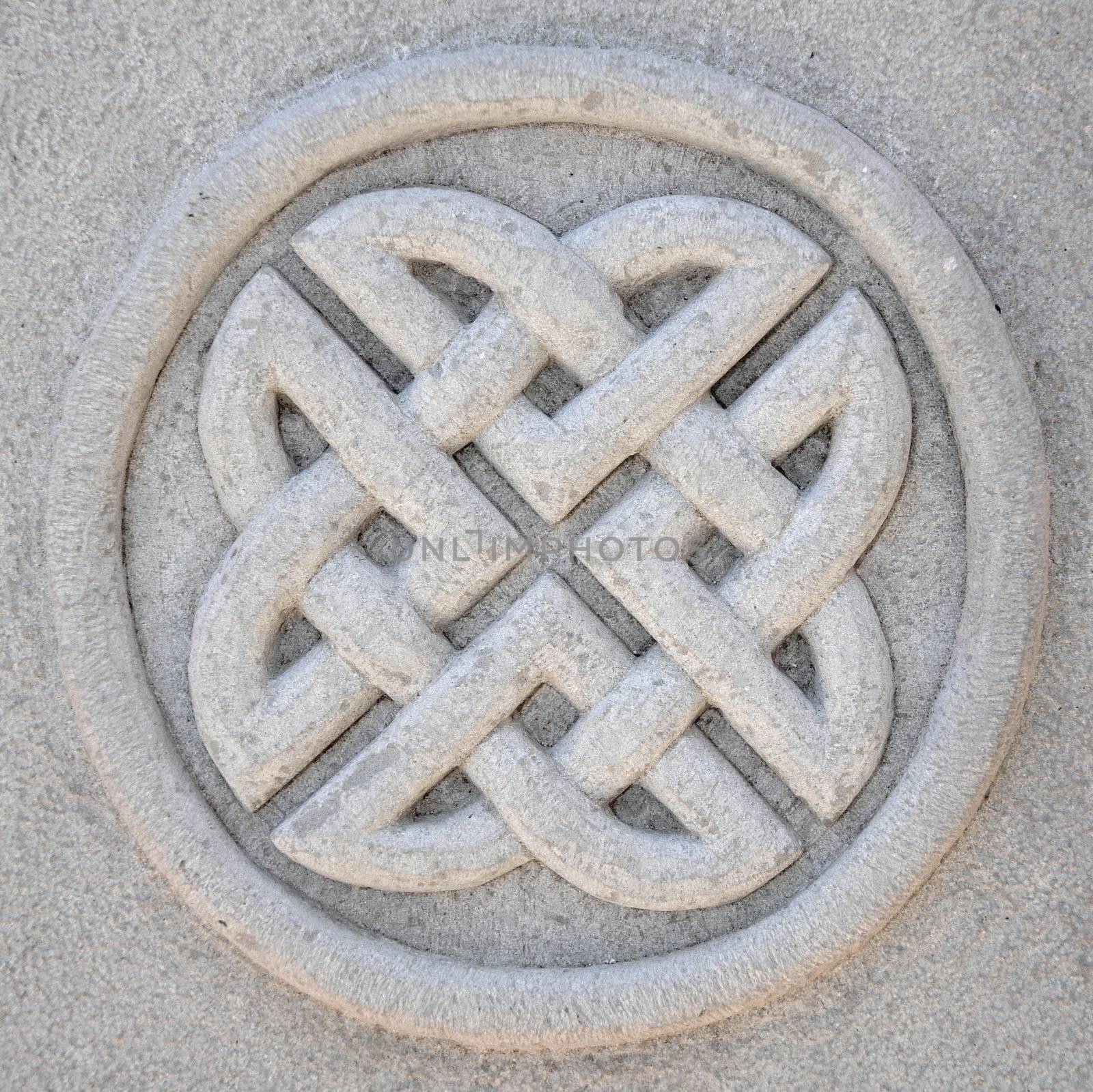 Sculptured circular symbol decoration on a stone