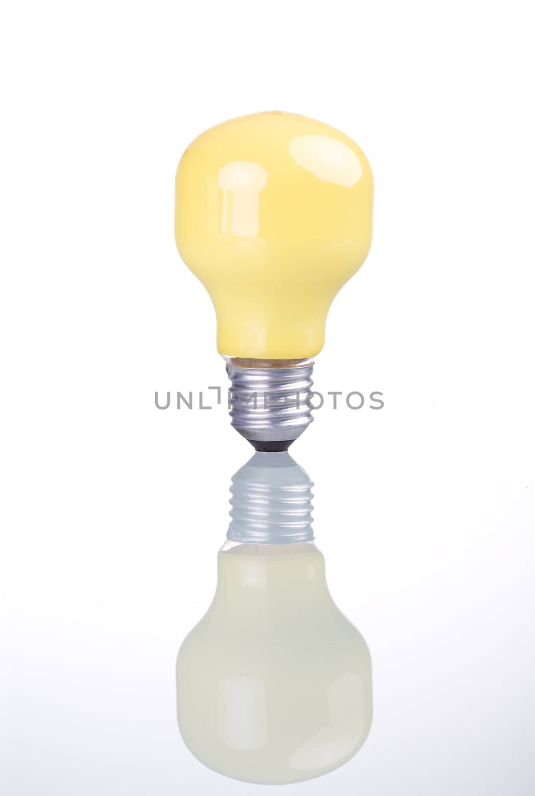 Yellow bulb with reflection, isolated on white background.