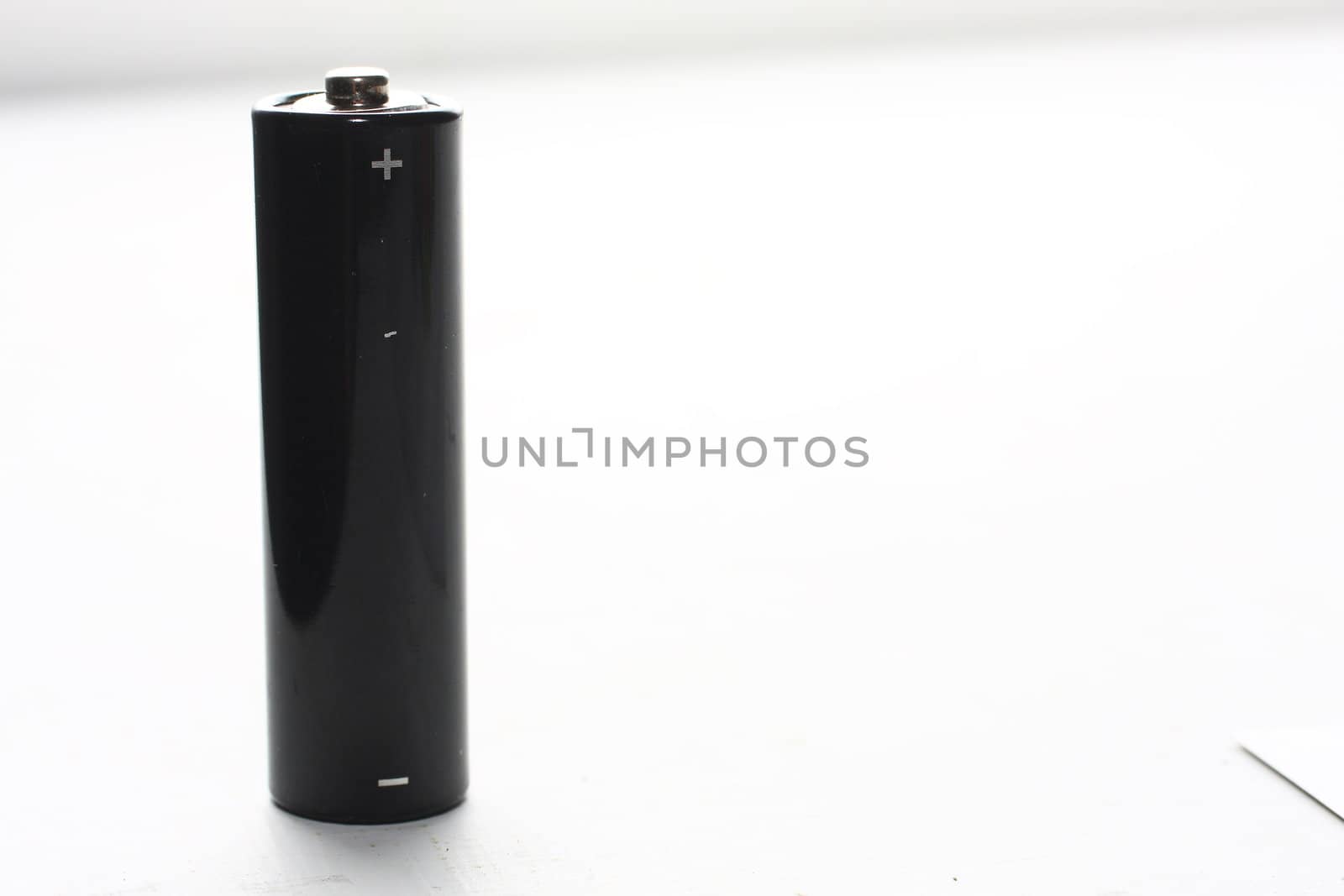 Black AA battery on white background
