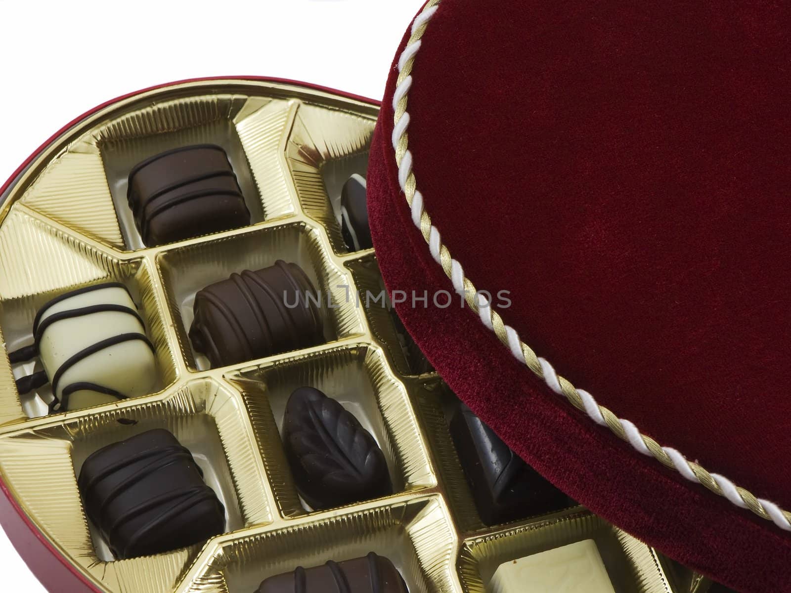 Opened box of valentines chocolates isolated on white