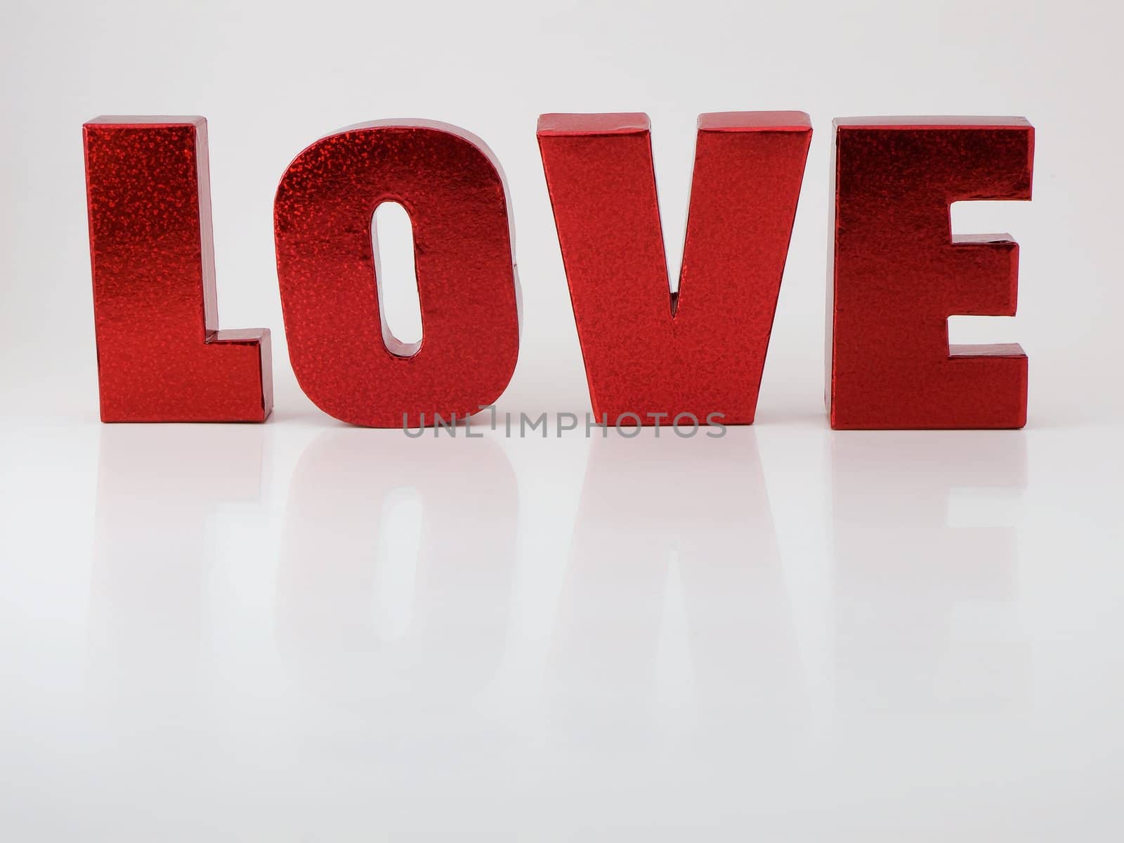 Red letters that spell love with reflection

