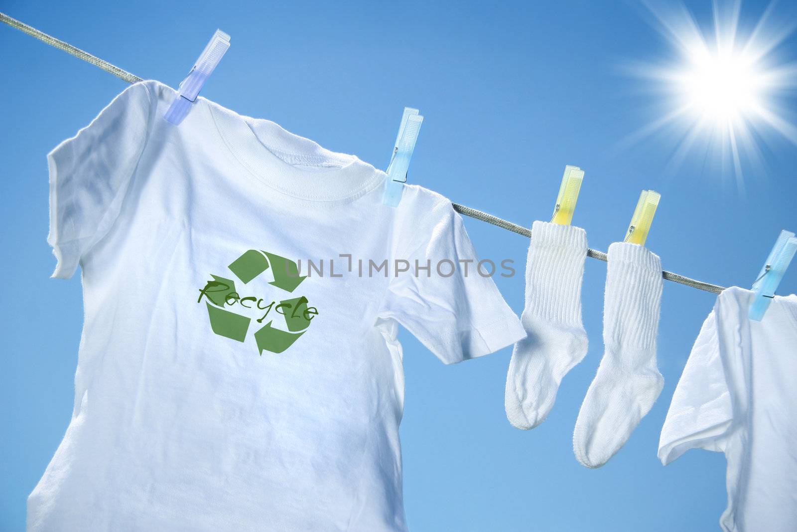 T-shirt with recycle logo drying on clothesline on a hot summer day