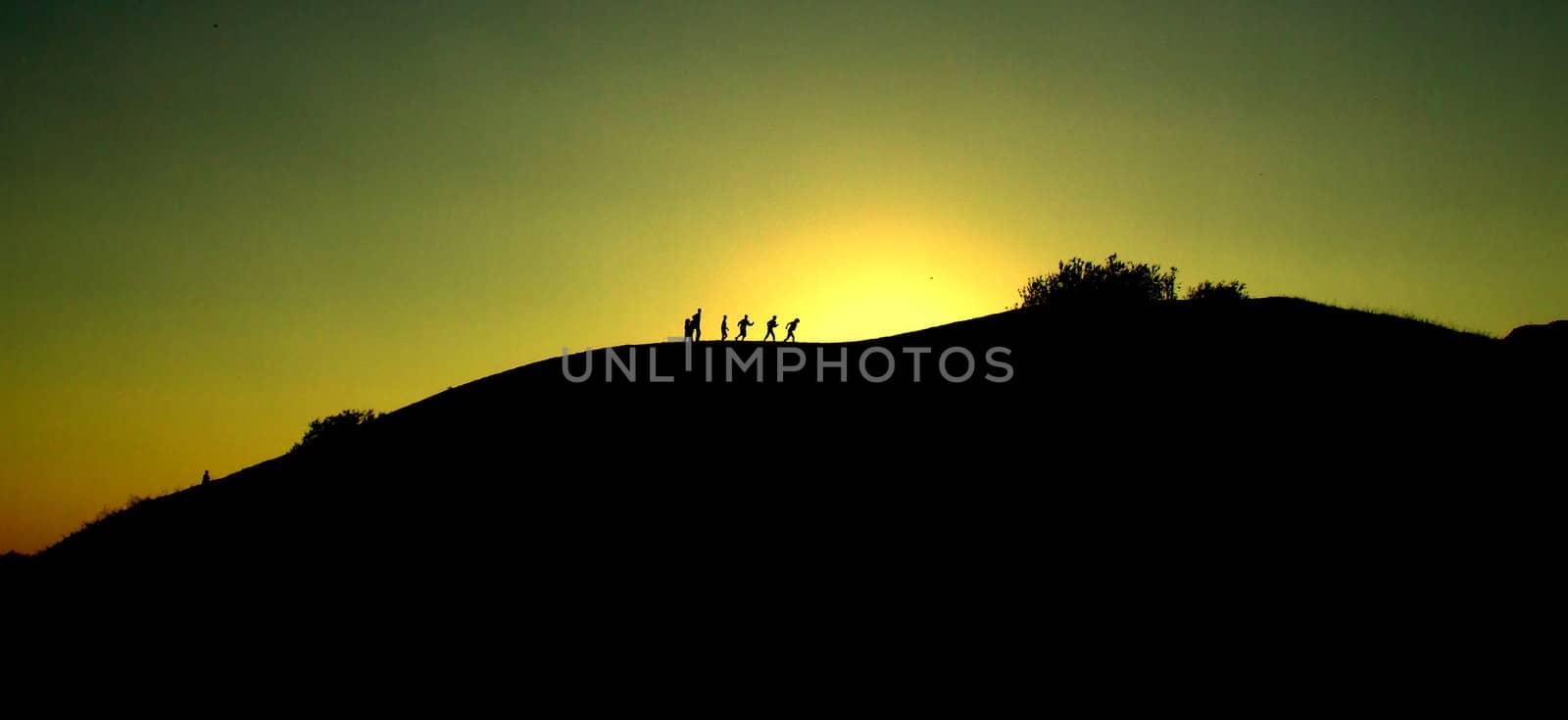 group of people walking trough mountain, one must rest.