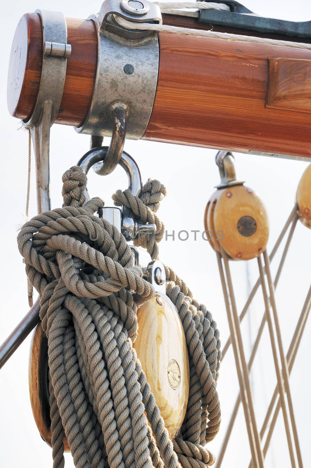 Wooden boom with blocks and ropes on a sailboat