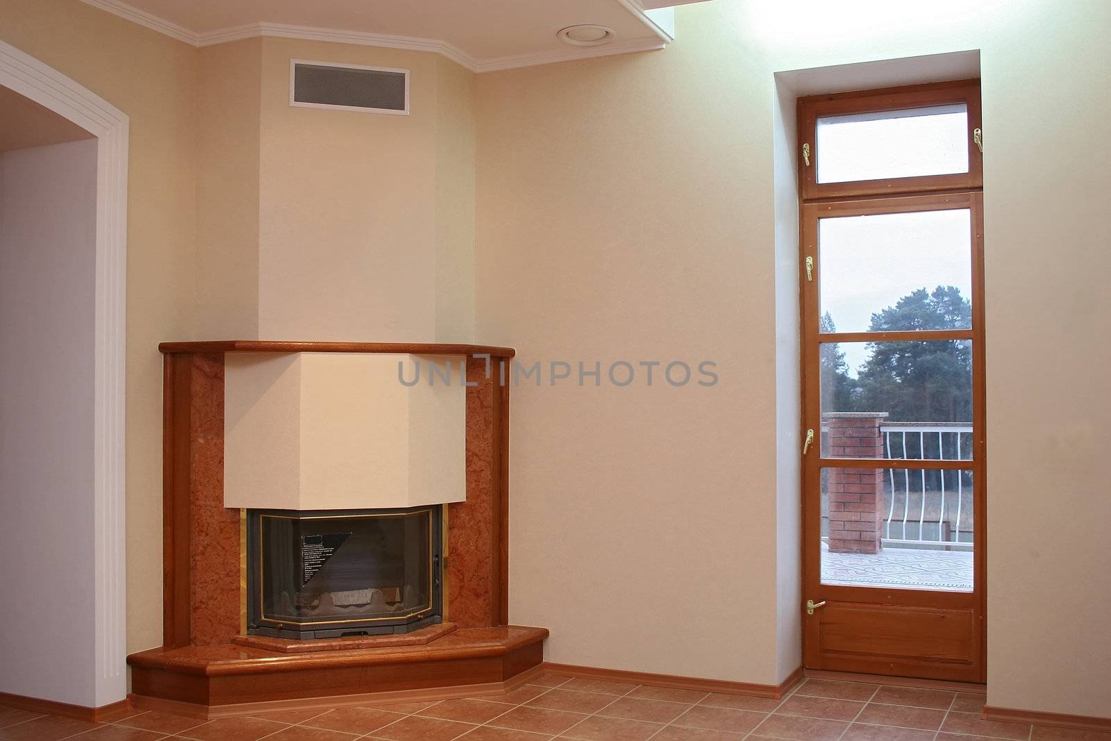 

Empty room with a tiled floor, a fireplace and a door on a terrace